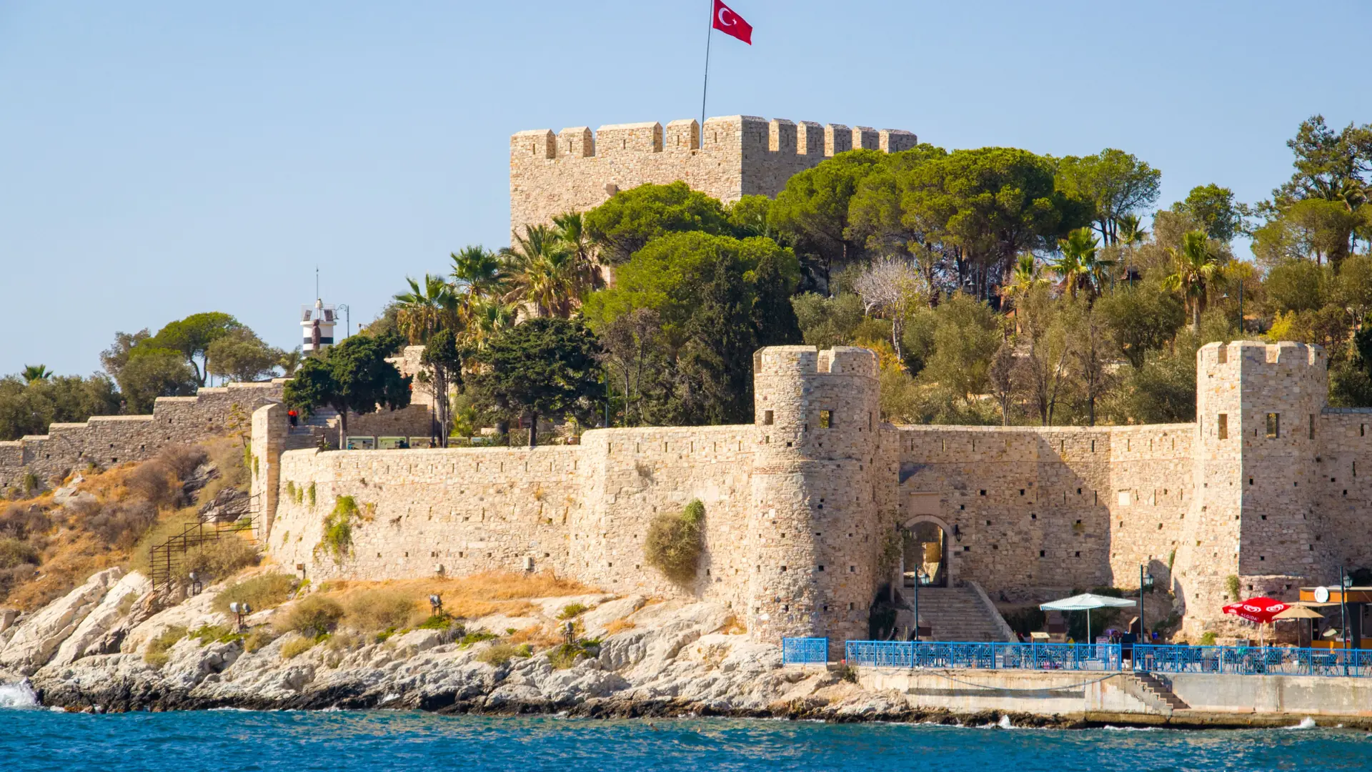 Sunny Kuşadası waterfront and Pigeon Island castle surrounded by deep blue Aegean water