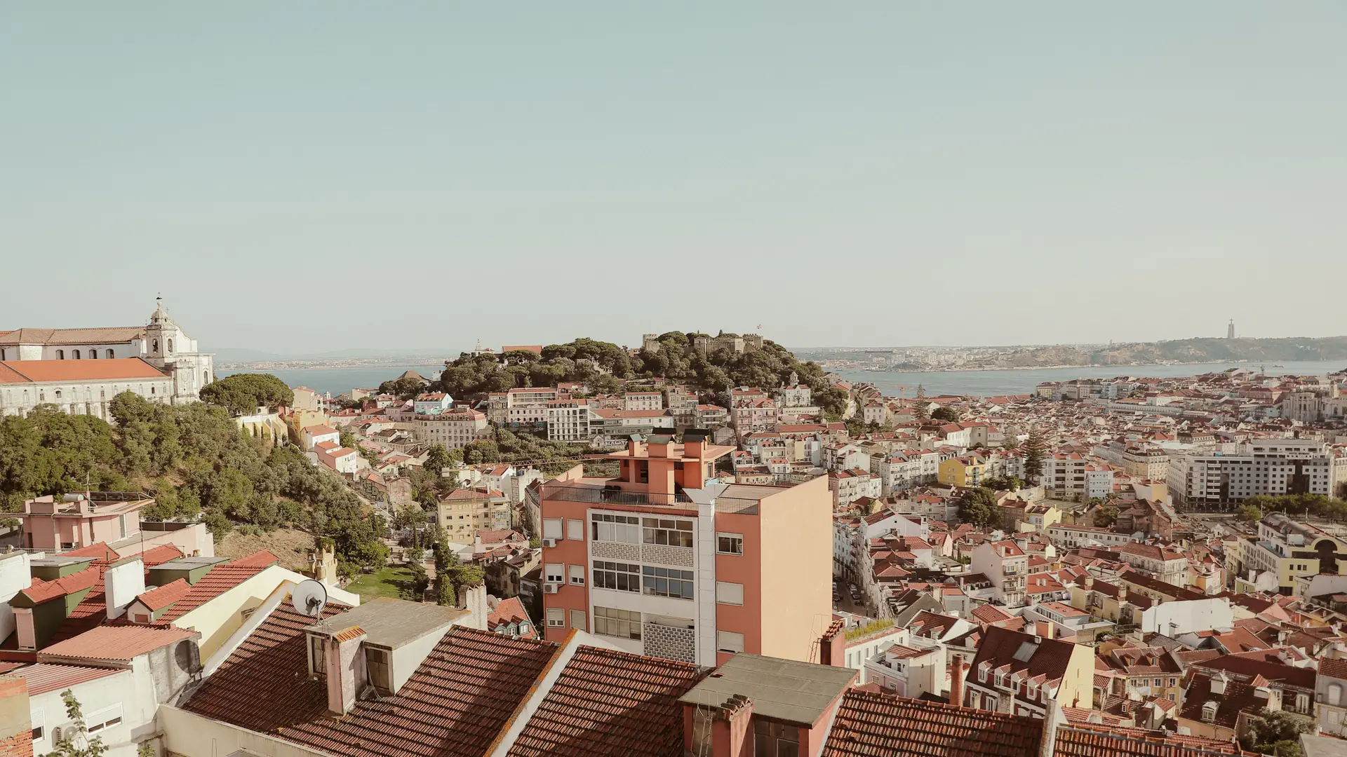 Lisbon's terracotta roofs, Tagus waterfront and historic centre in clear morning light