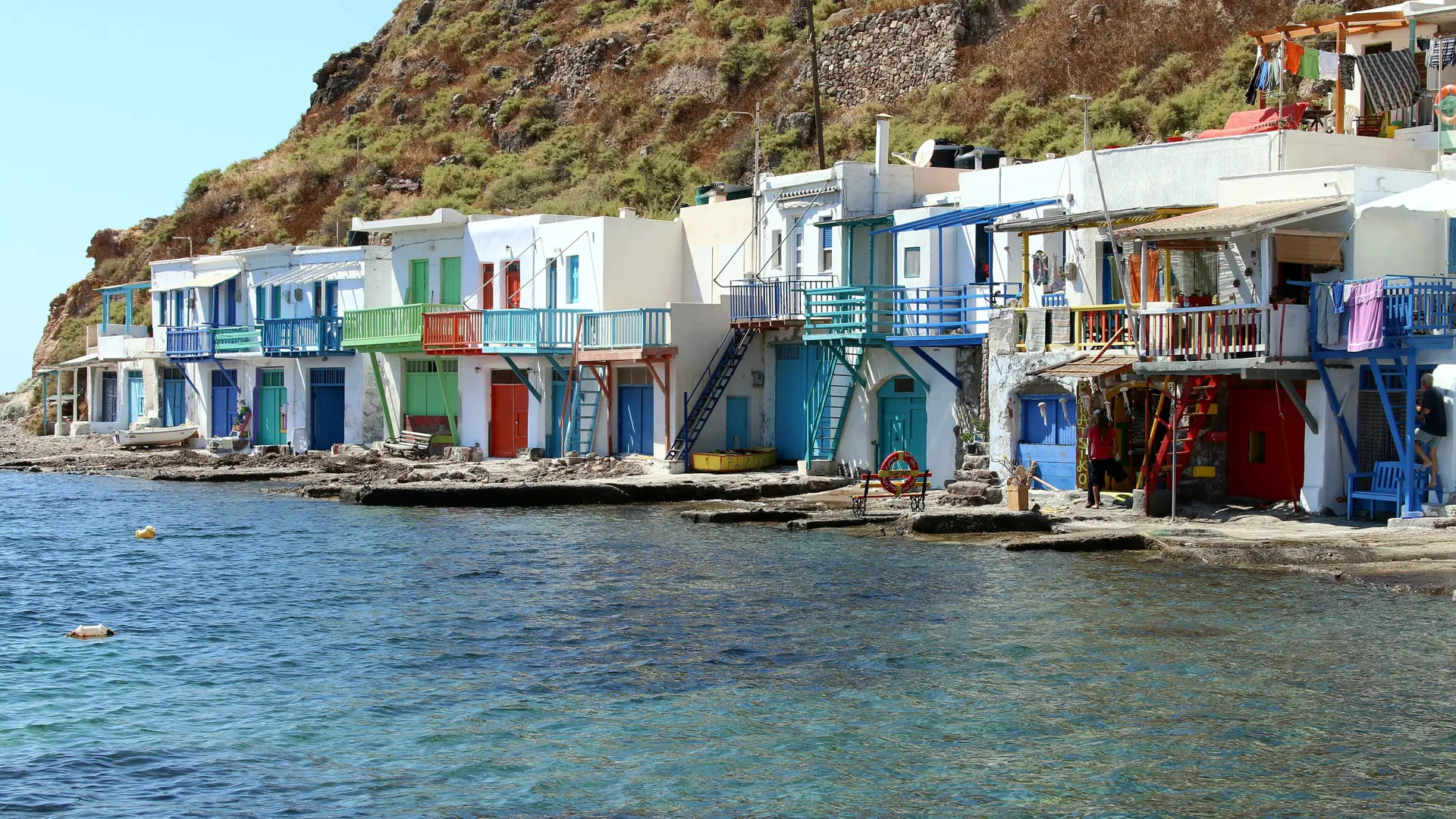 Colourful fishermen's houses and boat garages lining the water at Klima, Milos