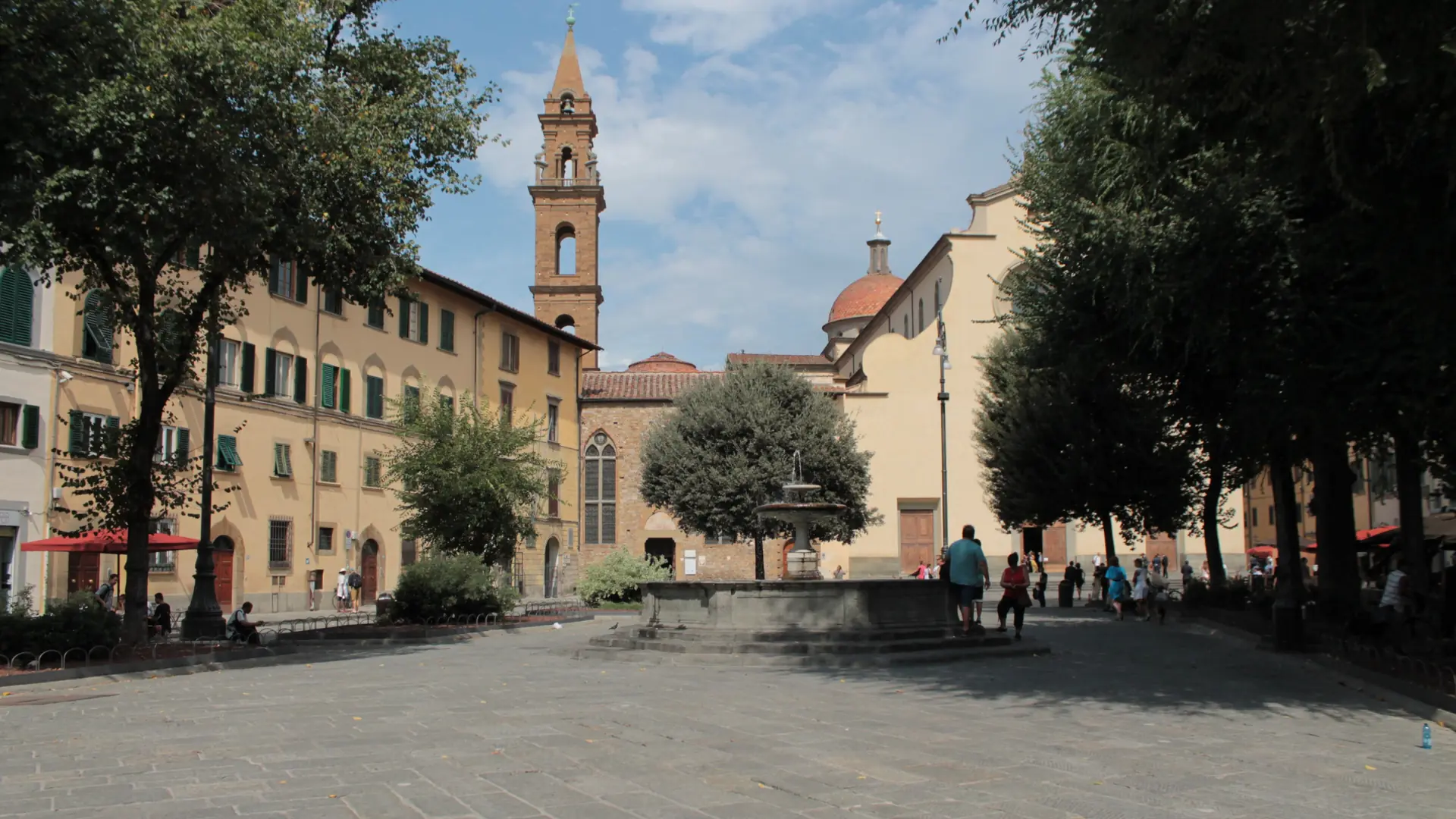 sunny Santo Spirito square with Renaissance façades, market stalls and café terraces in Florence