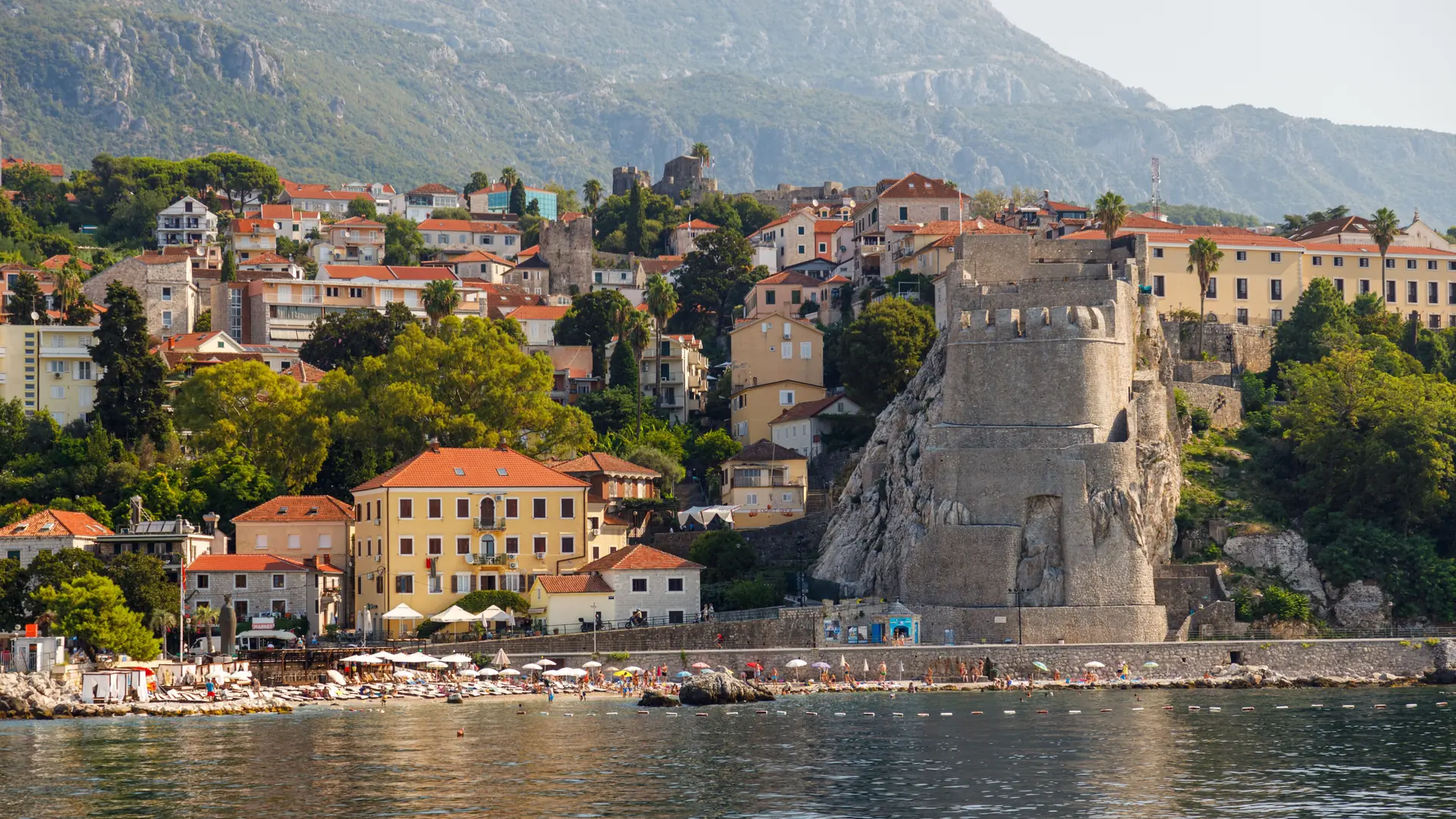 Herceg Novi's stone fortifications and waterfront above the blue Bay of Kotor