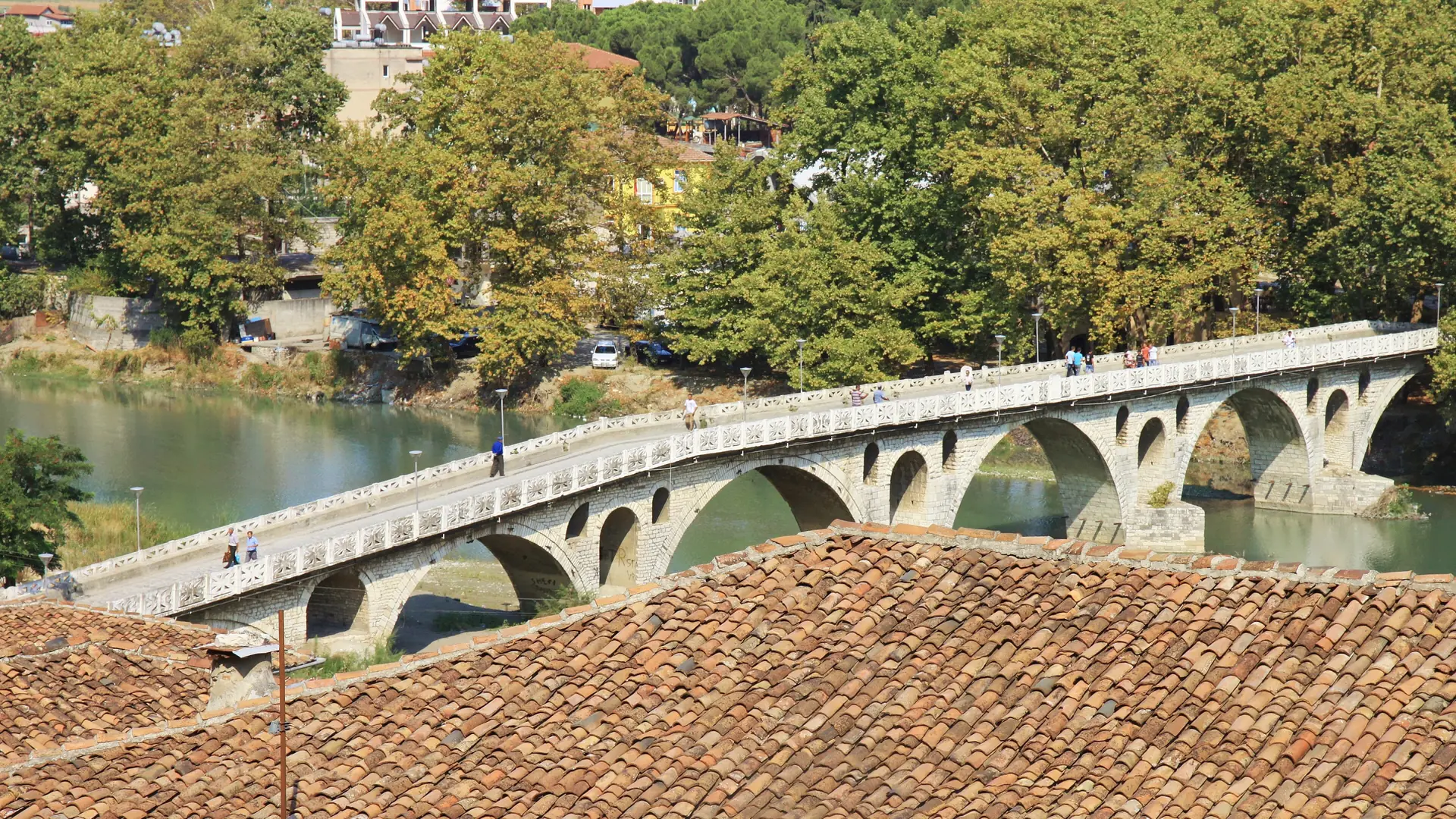 The arched stone Gorica bridge over the Osum river in Berat on a sunny day