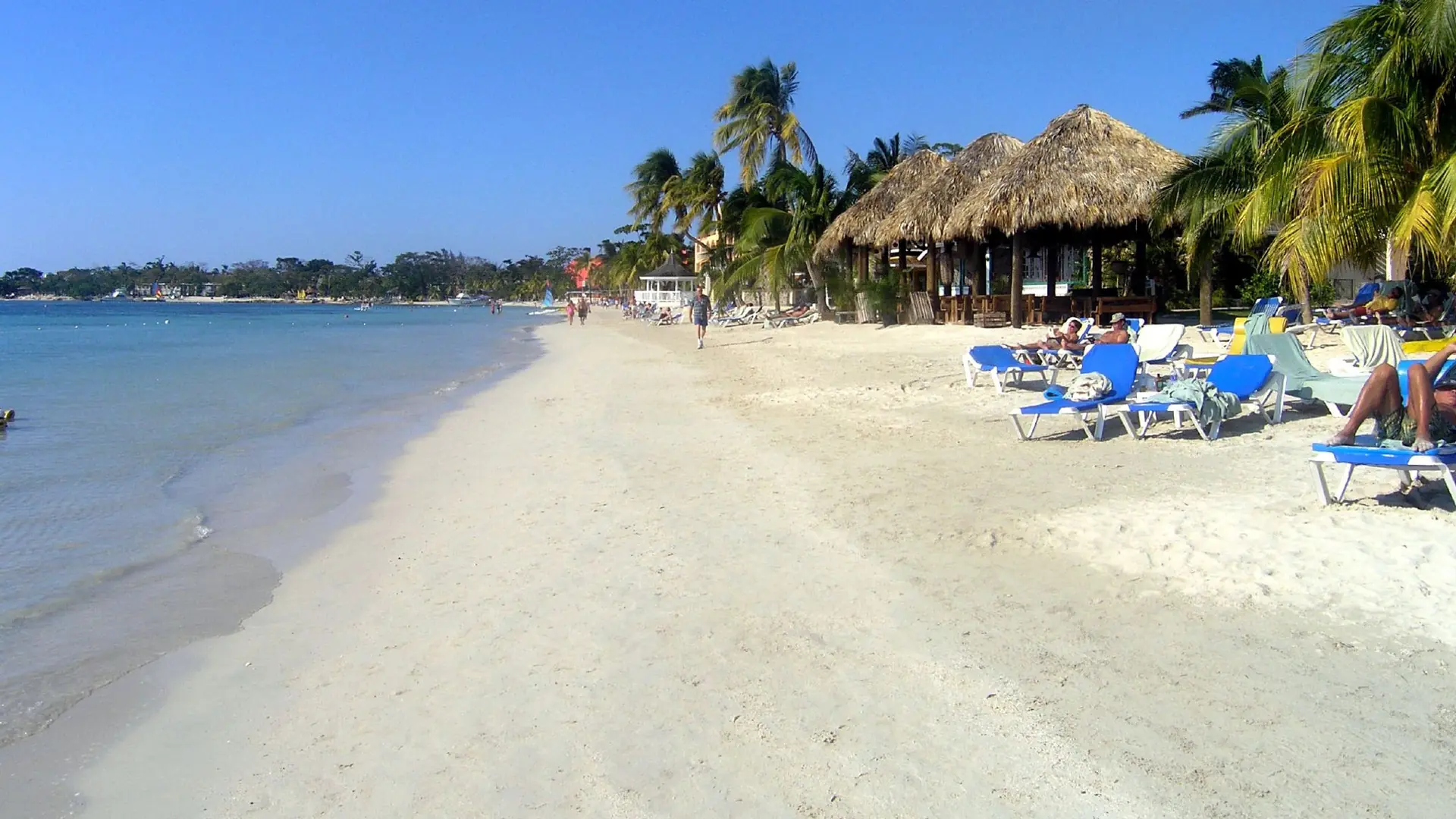 Sand, palms and beachfront buildings along the Negril coast
