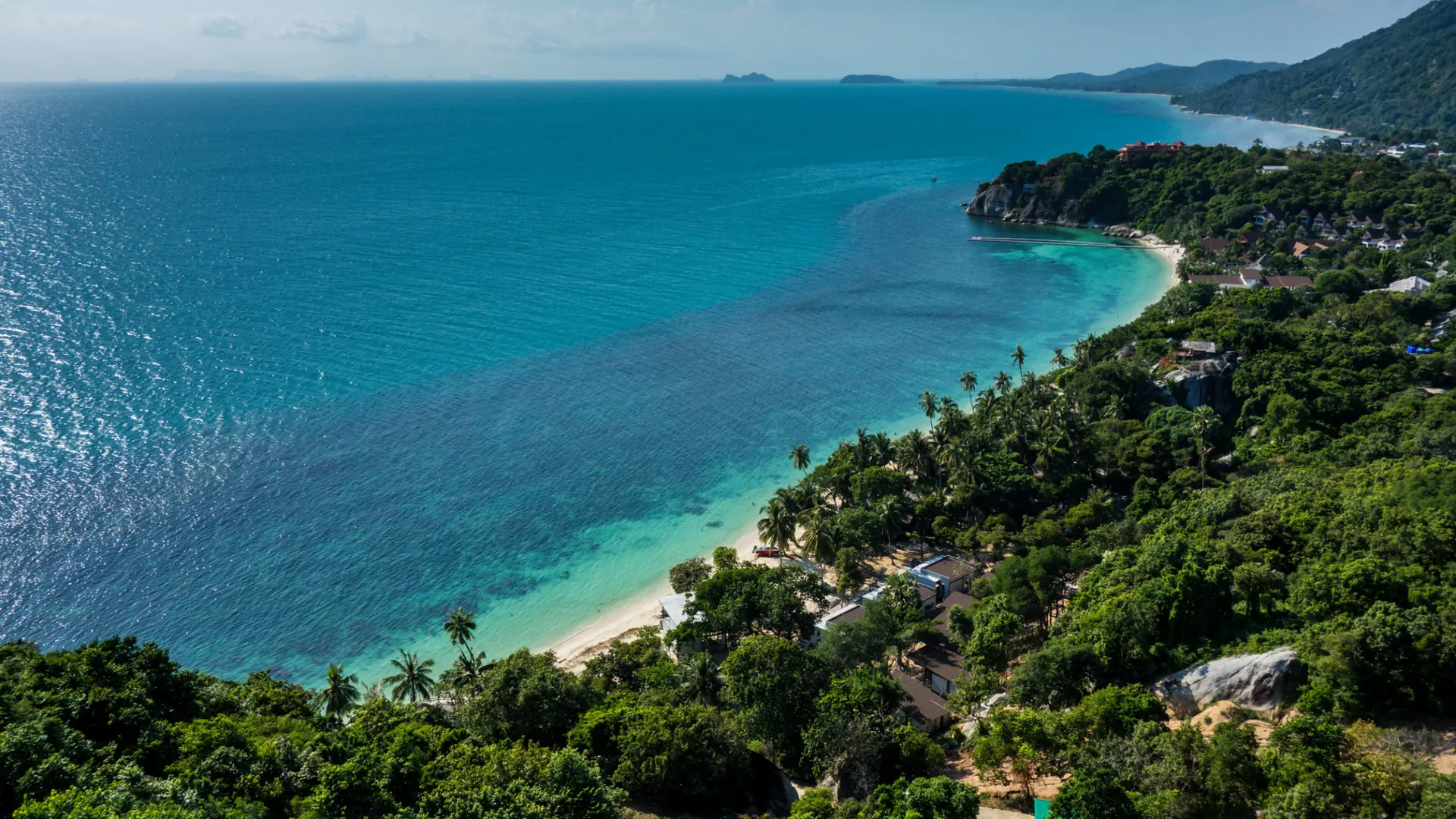 Sunlit coastline and turquoise bays on Koh Phangan
