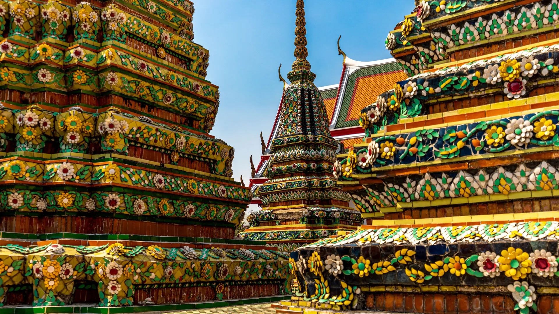 Sunlit decorated chedis at Wat Pho in Bangkok