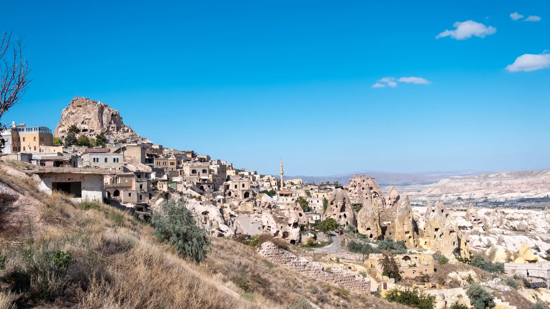 Ortahisar rock castle rising above the sunny Cappadocia village