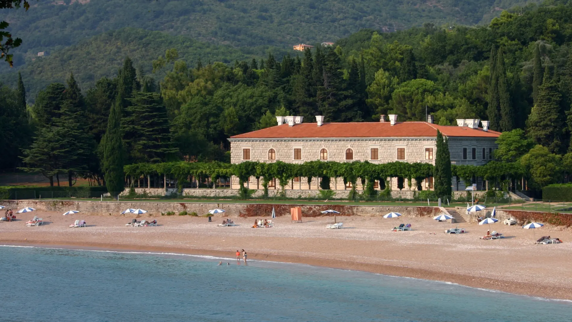 Villa Miločer behind the beach and pine trees near Sveti Stefan