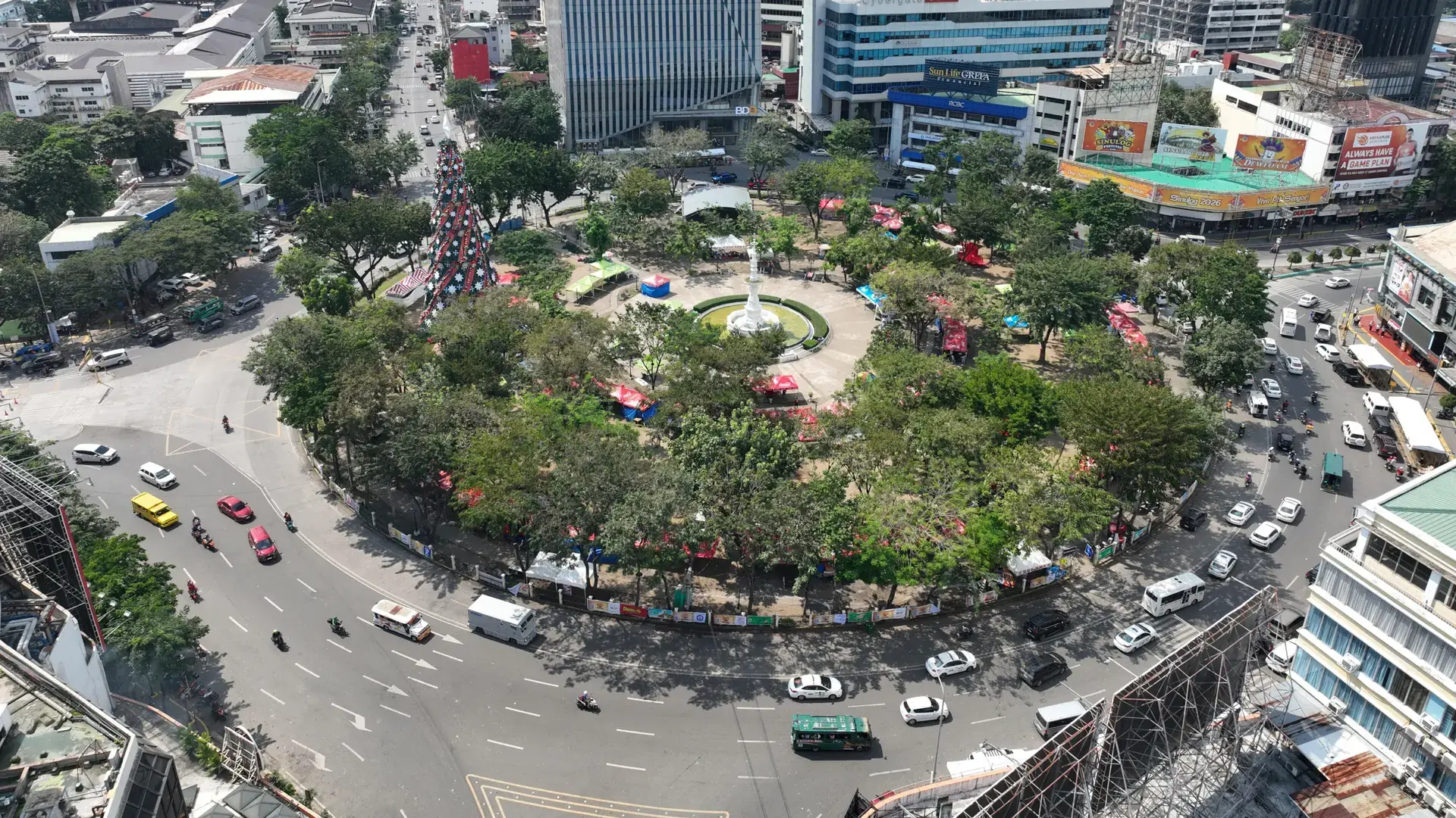 Aerial view of the green Fuente Osmeña Circle and its busy rotunda in central Cebu City