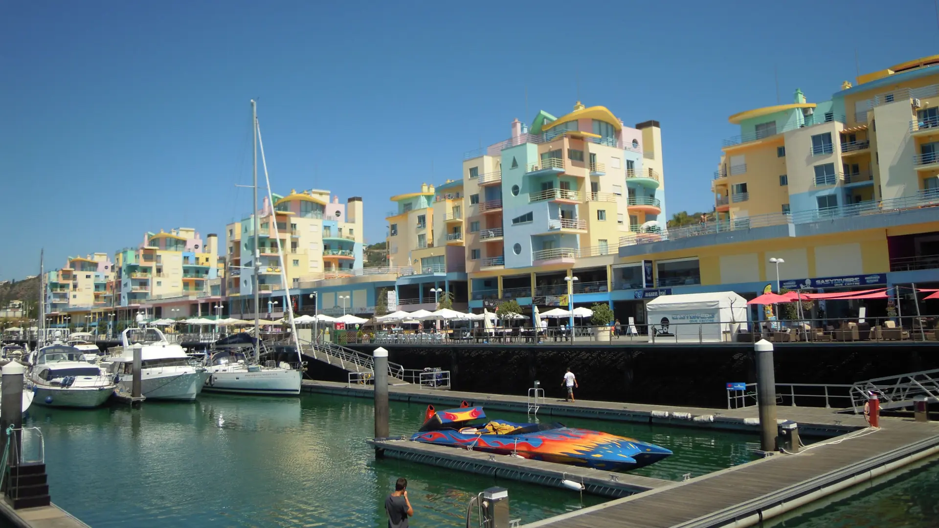 Boats moored beside colourful apartment façades at Marina de Albufeira