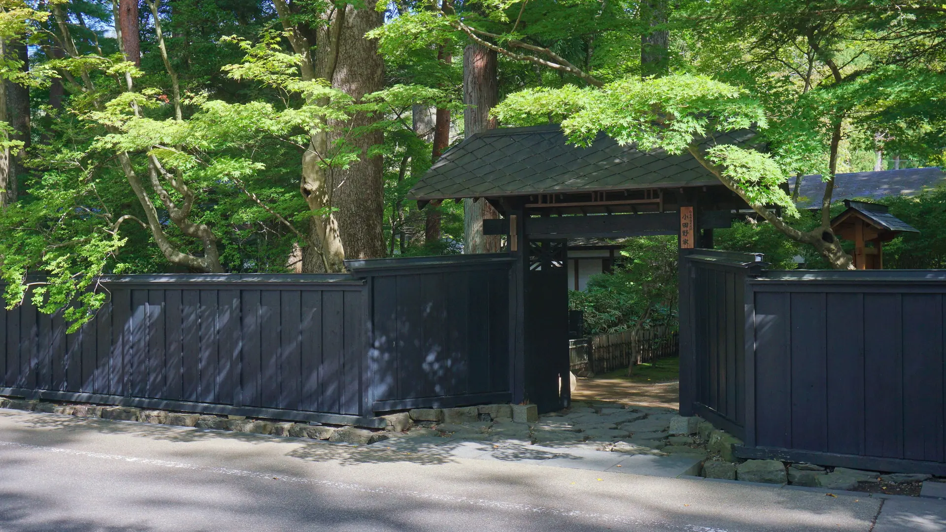 Dark timber samurai residences and leafy lanes in Kakunodate under clear daylight