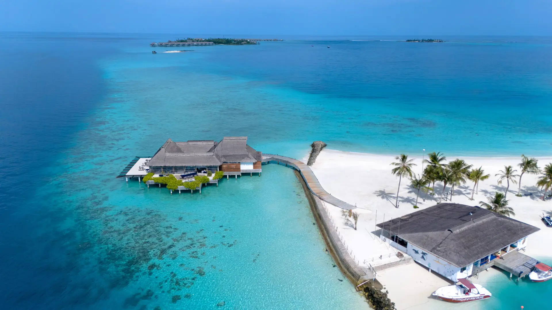 Aerial view of a Maldivian resort island and its arrival pier
