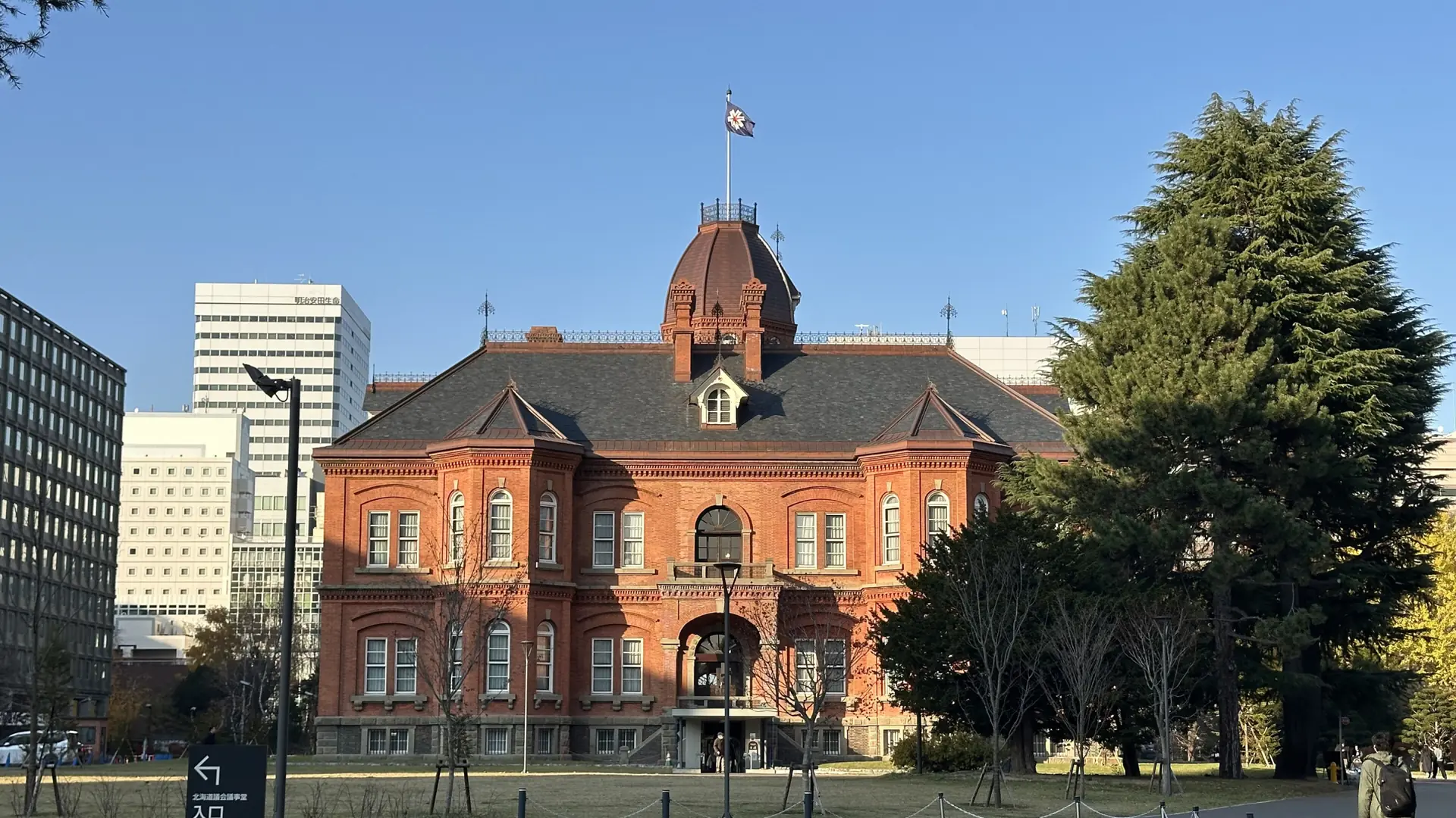 The red-brick Akarenga building and its octagonal roof beneath a blue Sapporo sky