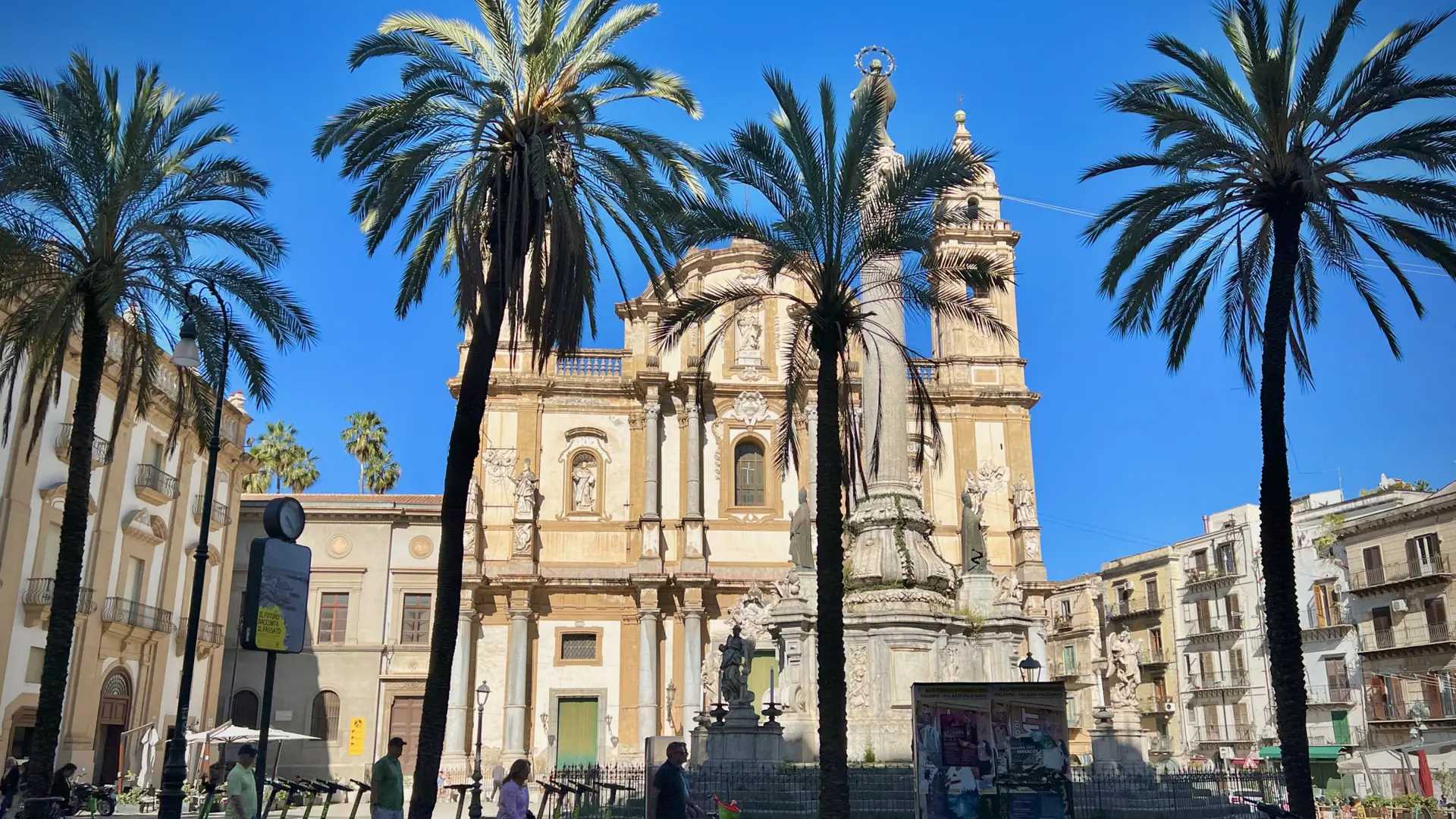 San Domenico church and the Immacolata column among palm trees in Palermo’s La Loggia quarter.