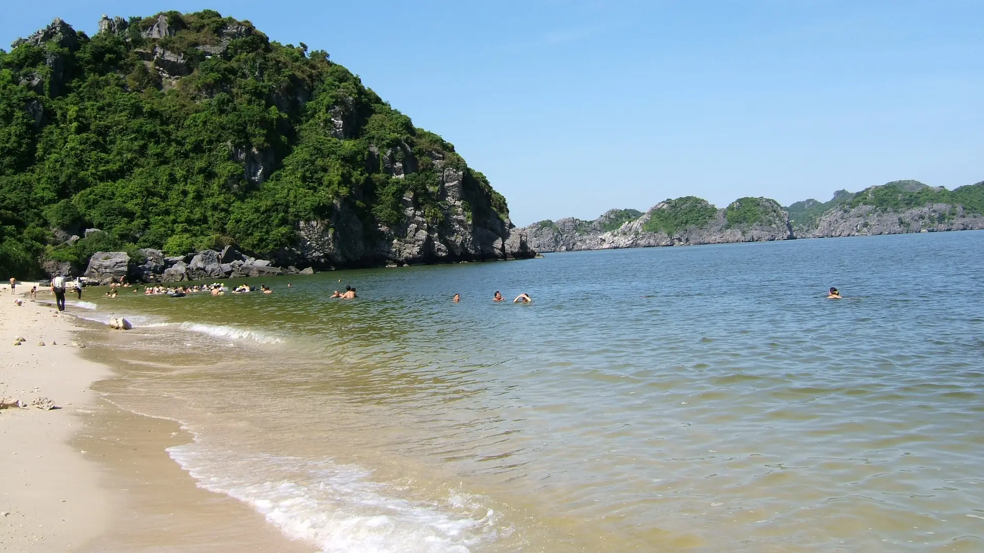Sunny Monkey Island beach in the Cat Ba archipelago, a wider coastline scene rather than Cat Co