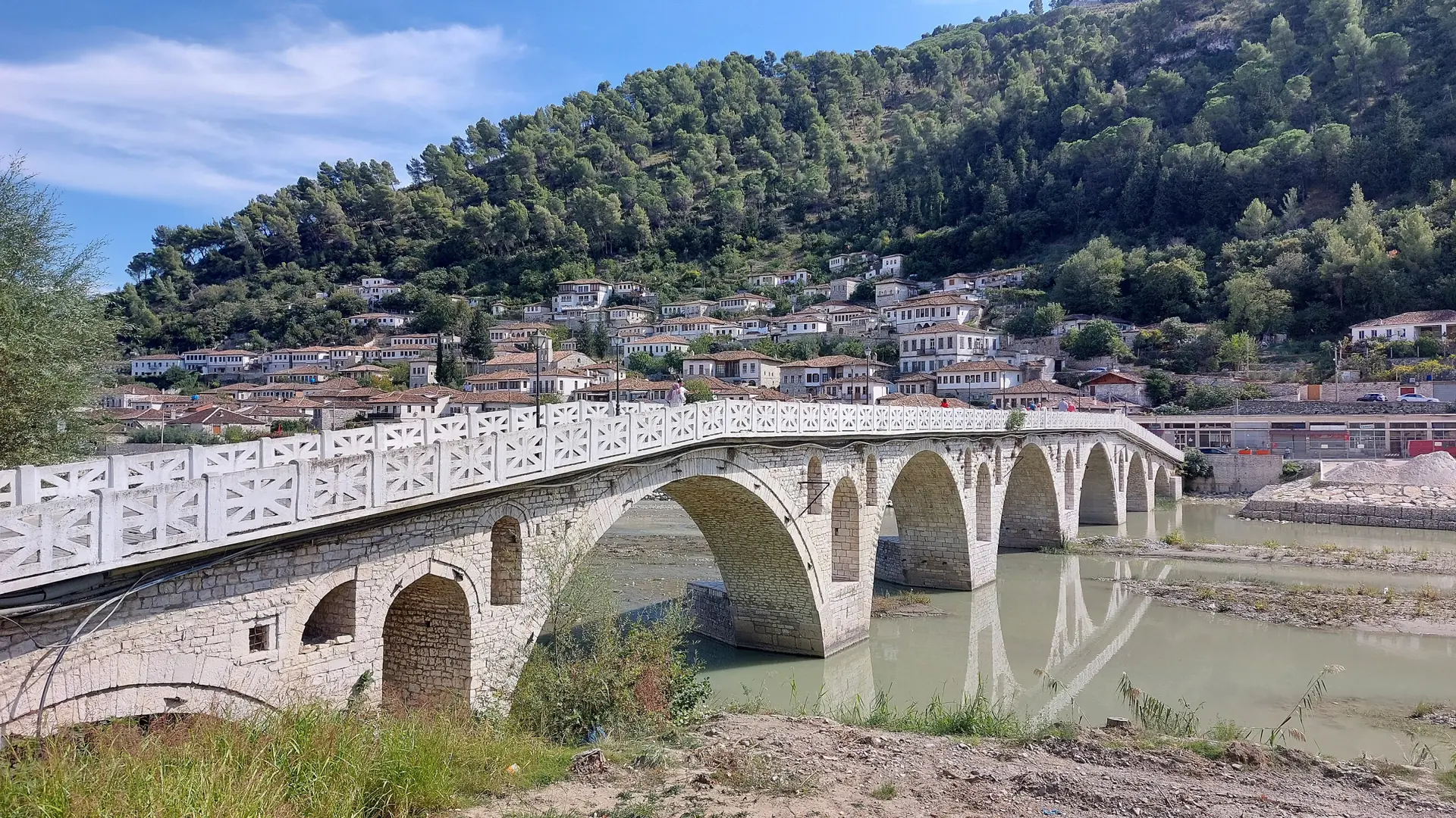 The old stone bridge over the Osum river leading to the Gorica quarter of Berat on a sunny day
