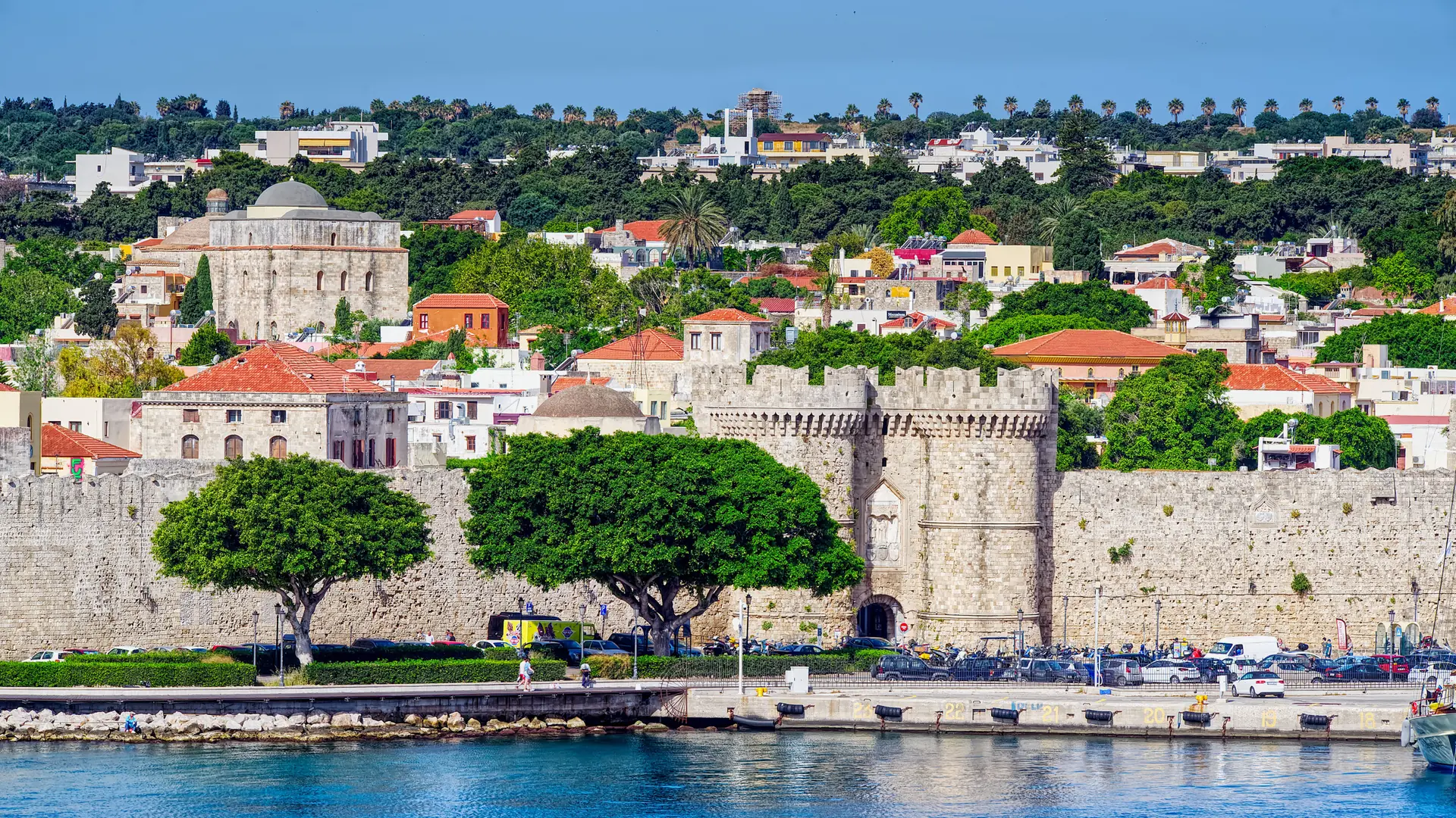 Rhodes Town's medieval waterfront walls and towers in bright summer light