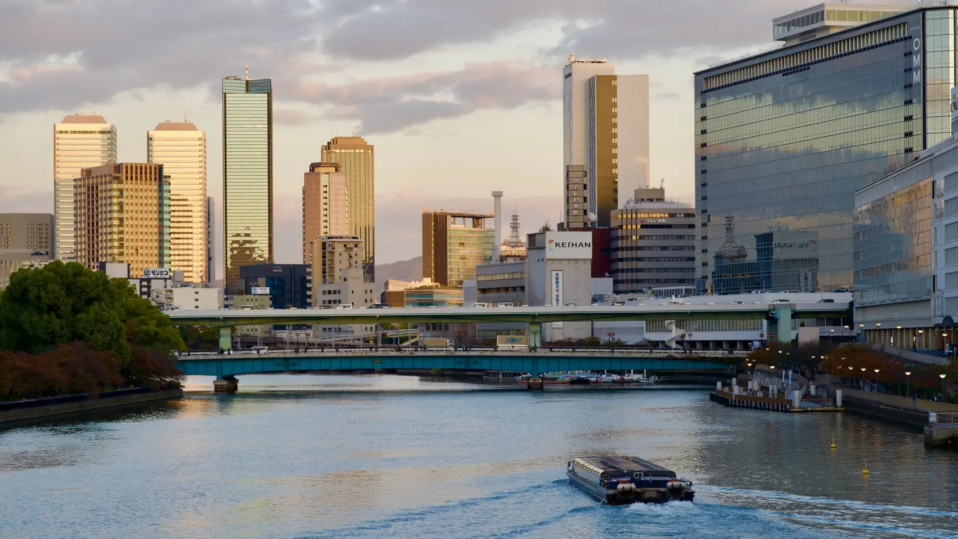 sunlit Nakanoshima riverside and elegant central Osaka buildings