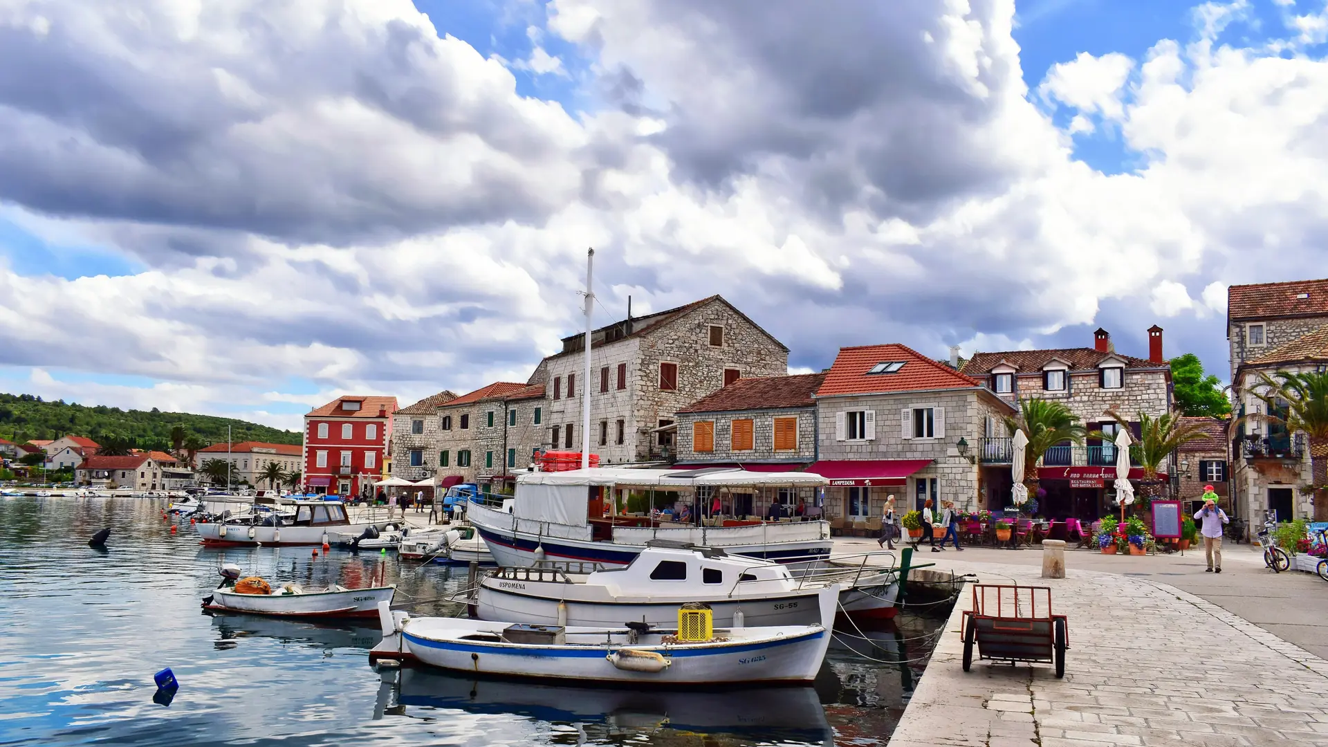 Small boats moored beside the historic buildings of Stari Grad on Hvar island