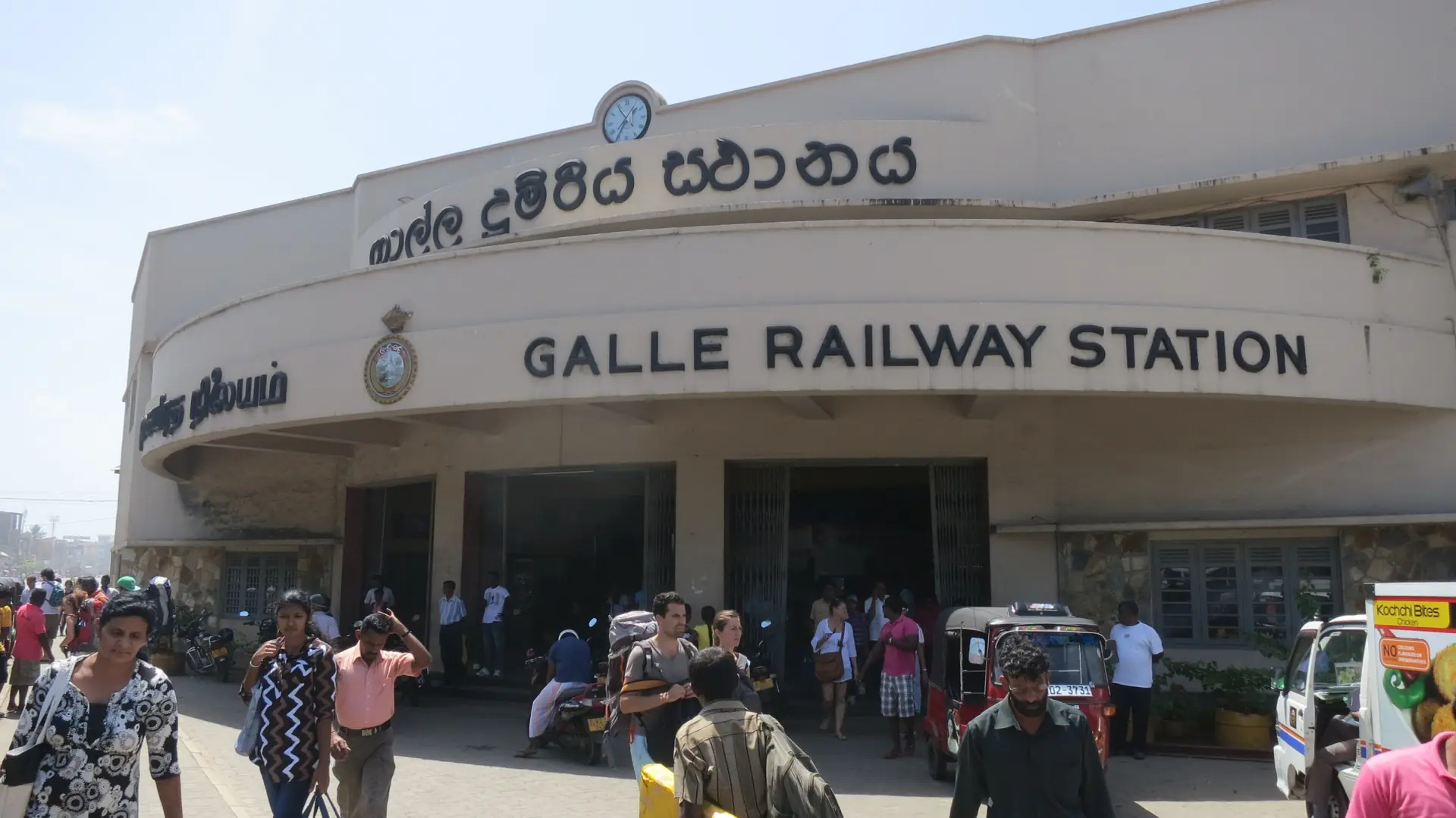 Galle railway station entrance and travellers outside the Fort in daylight
