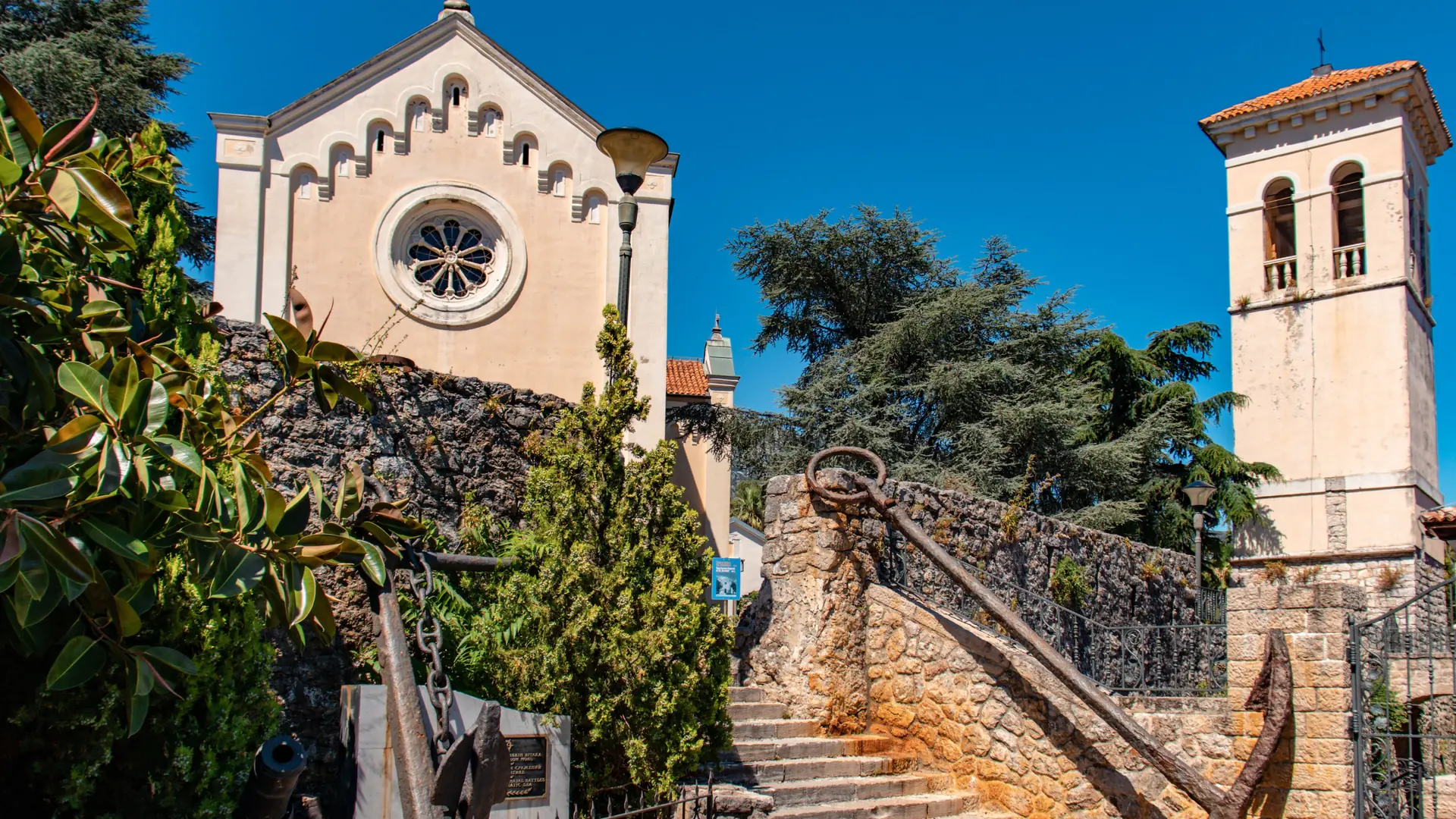 Stone steps to St Jerome's Church and bell tower in Herceg Novi under a blue sky