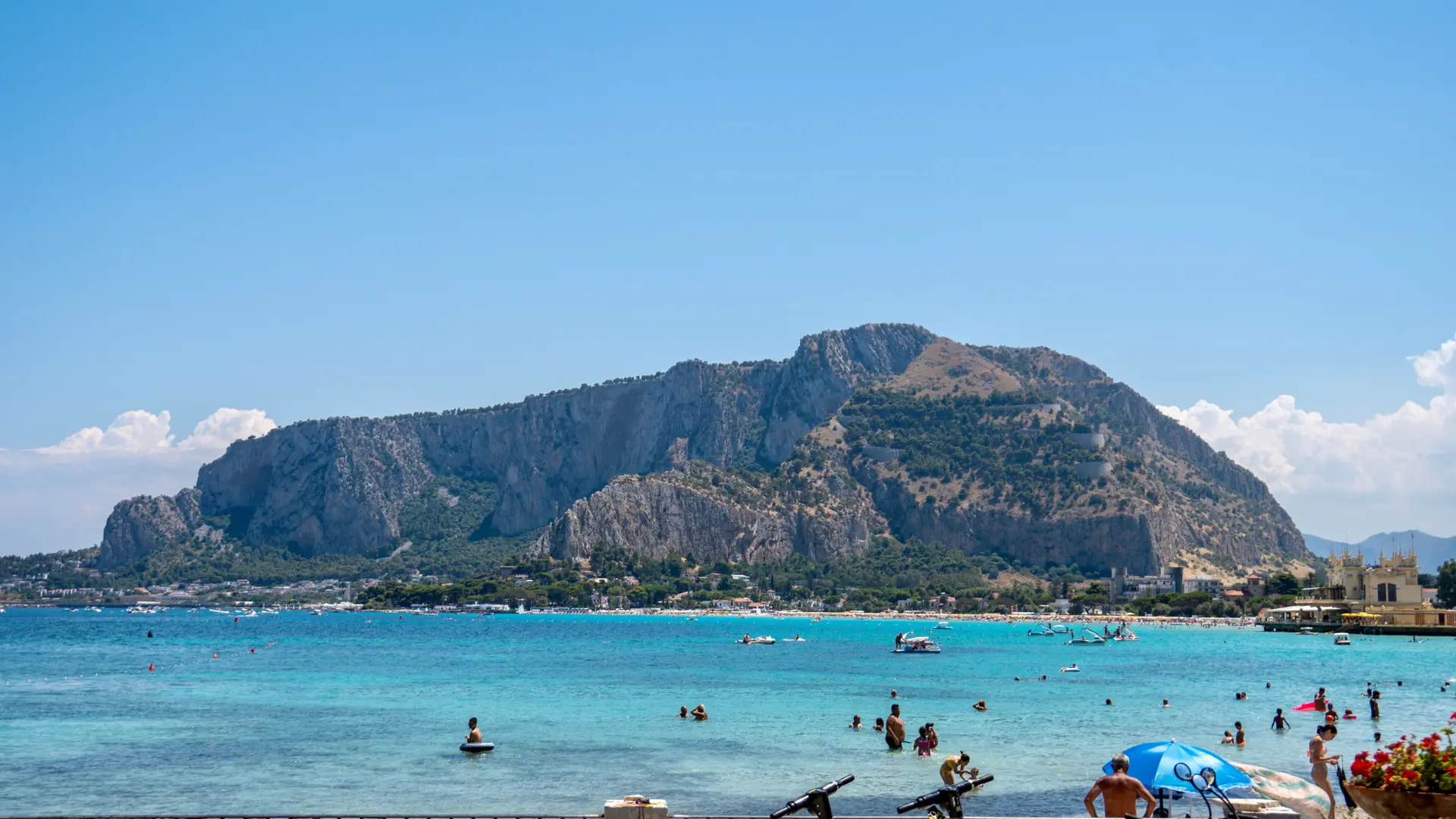 bright Mondello beach with clear turquoise water, pale sand and Liberty-style seafront villas near Palermo