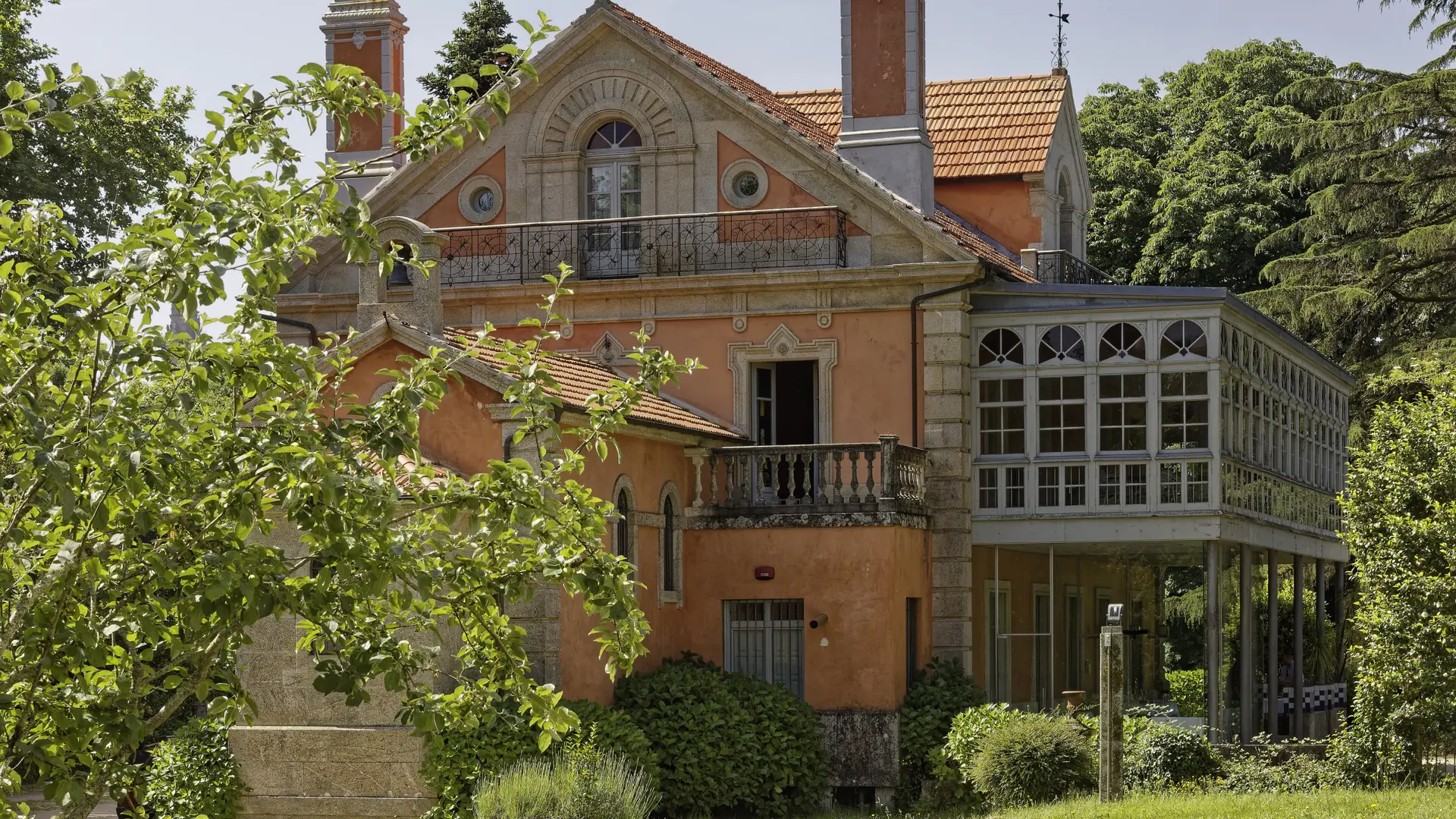 Casa Europa’s orange walls and white veranda in Vista Alegre park