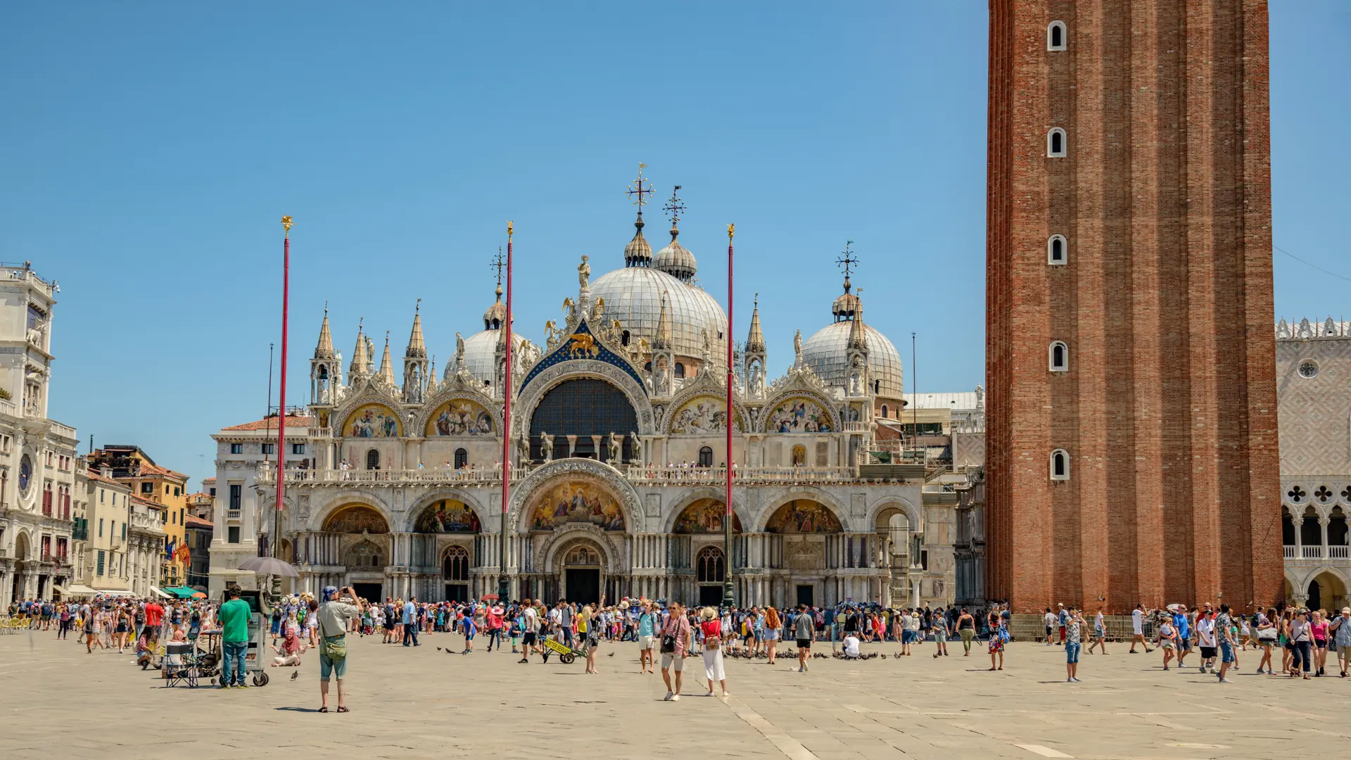 St Mark's Basilica and Campanile under a bright blue sky in Venice