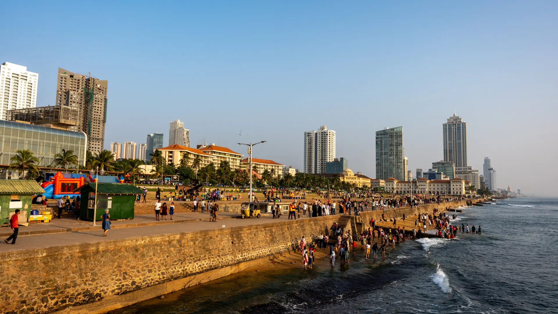 People strolling beside the sea at Colombo's Galle Face promenade