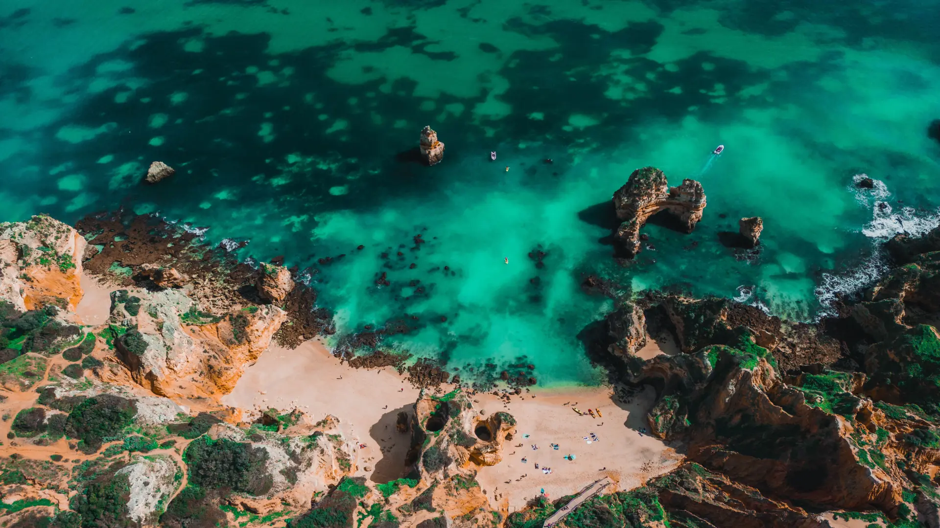 Golden sea arches and clear Atlantic water along the Lagos coast