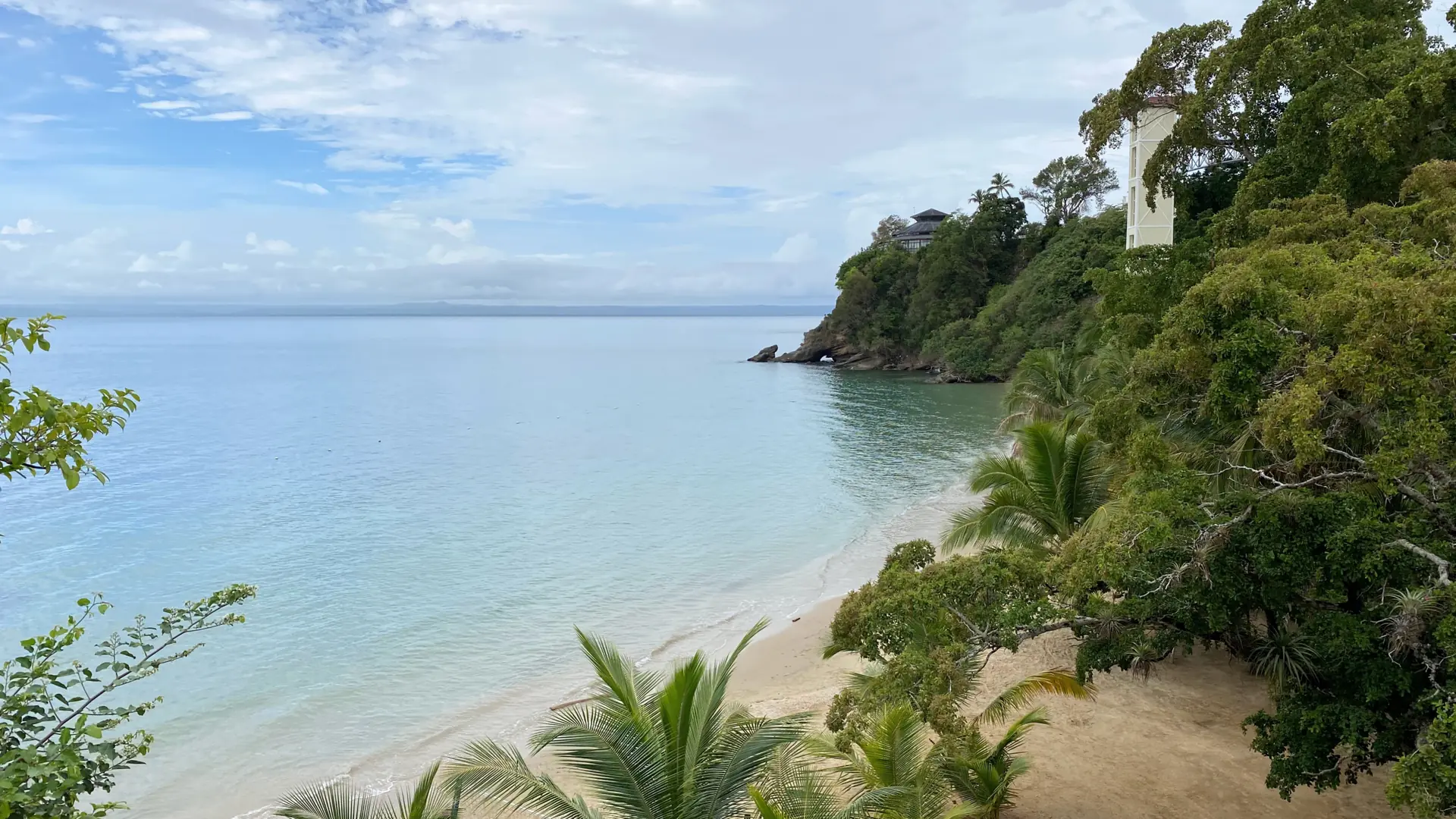 Samaná Bay beside a green hillside and a small sandy shore