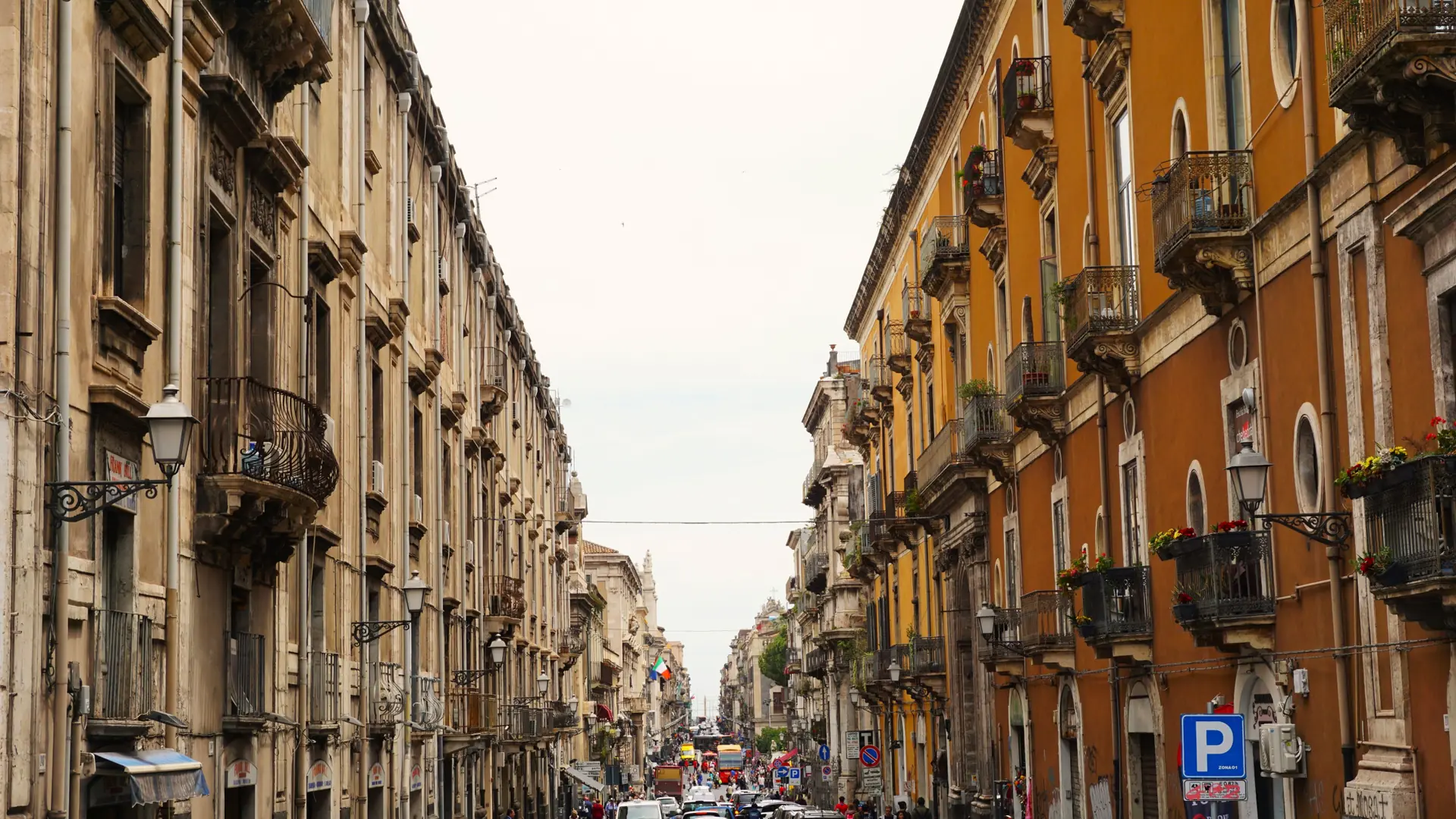 bright Via Etnea in Catania with wide boulevard, lava-stone paving and Mount Etna in the distance