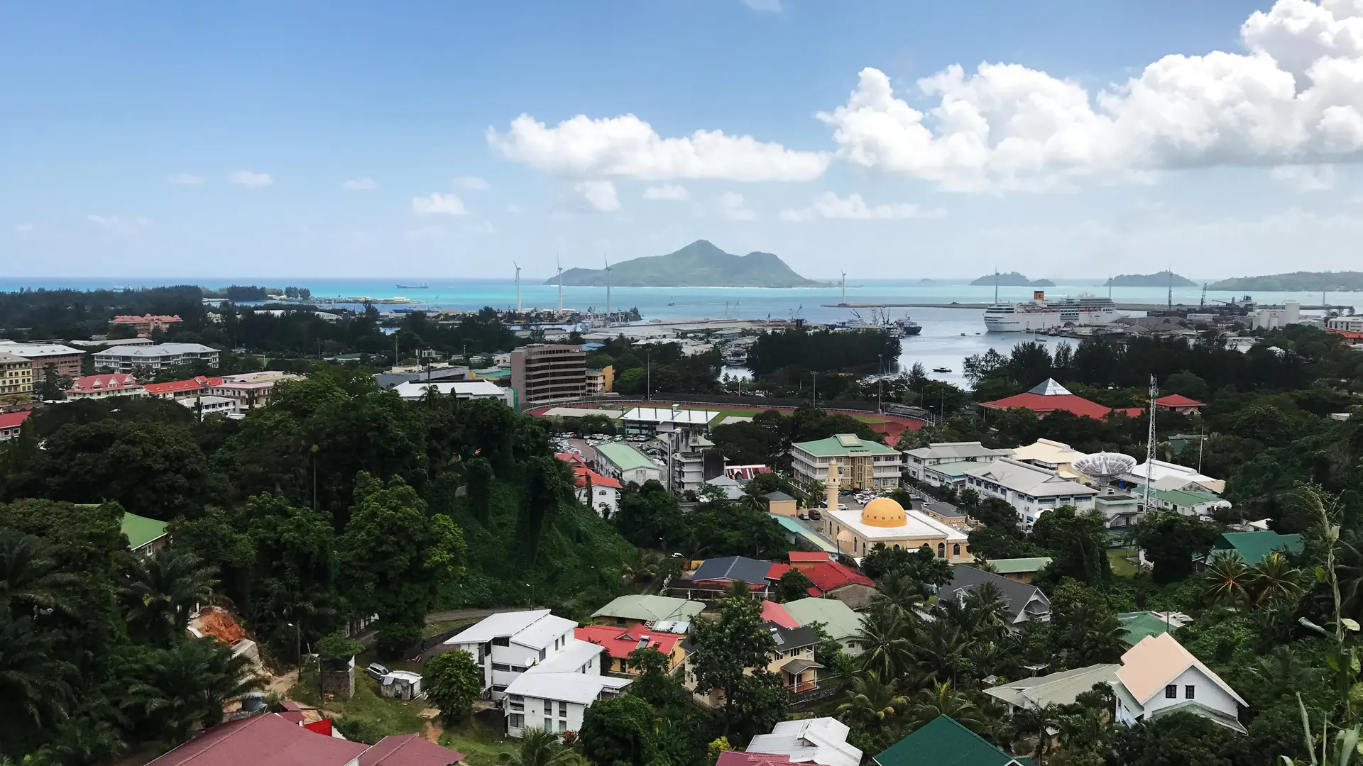 Daytime view over the roofs and green slopes of Victoria on Mahé; the English River district is not identified