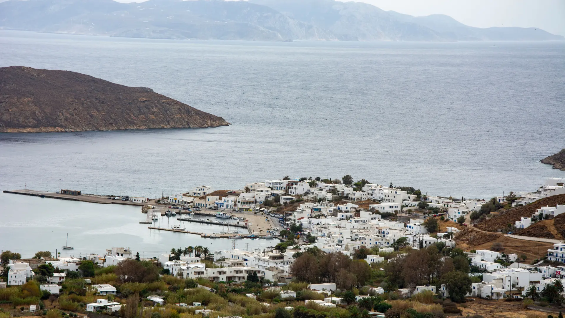 Whitewashed Serifos houses descending toward the island's deep blue harbour