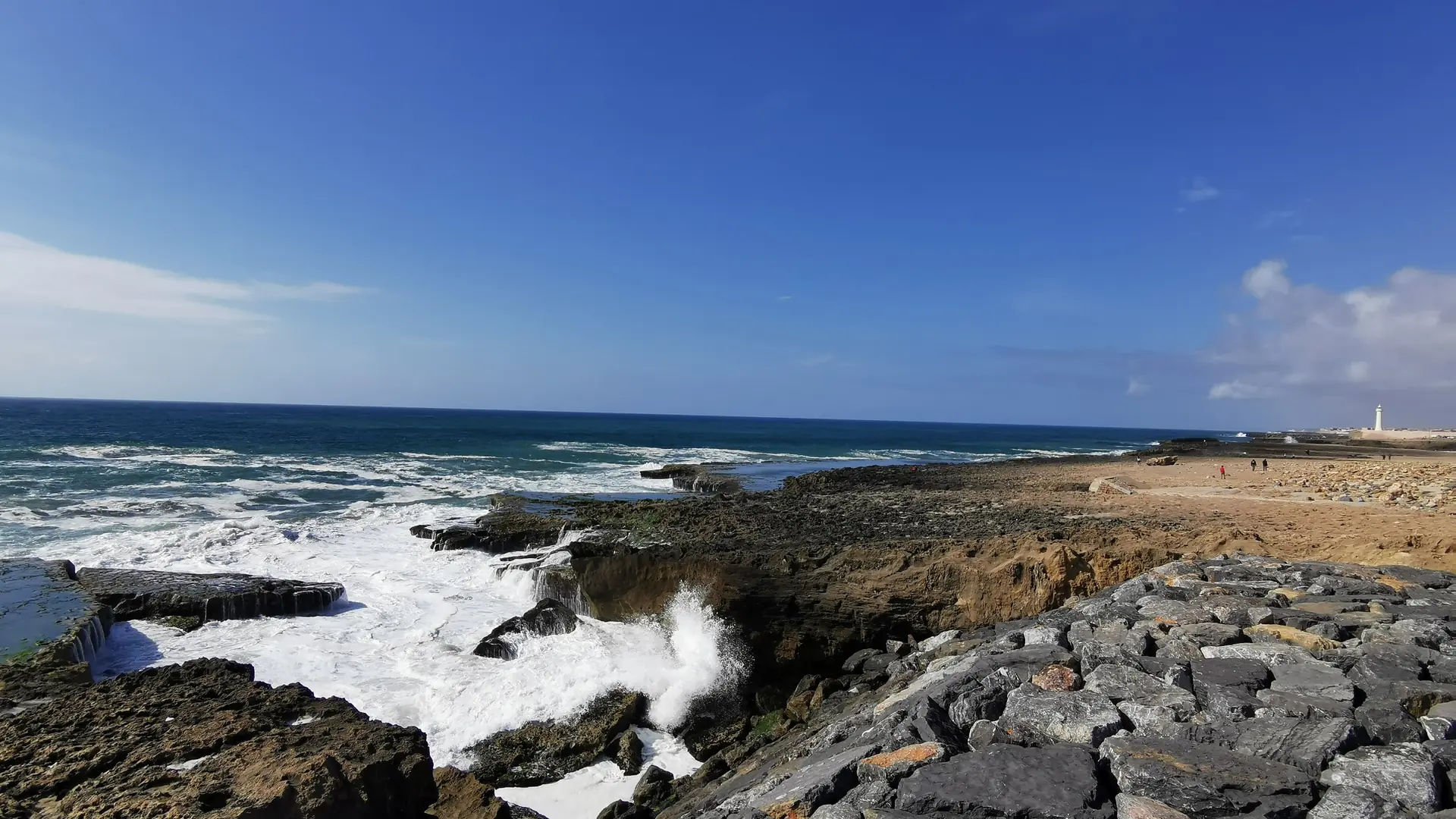 Rocky Atlantic shoreline in Rabat under a clear blue sky