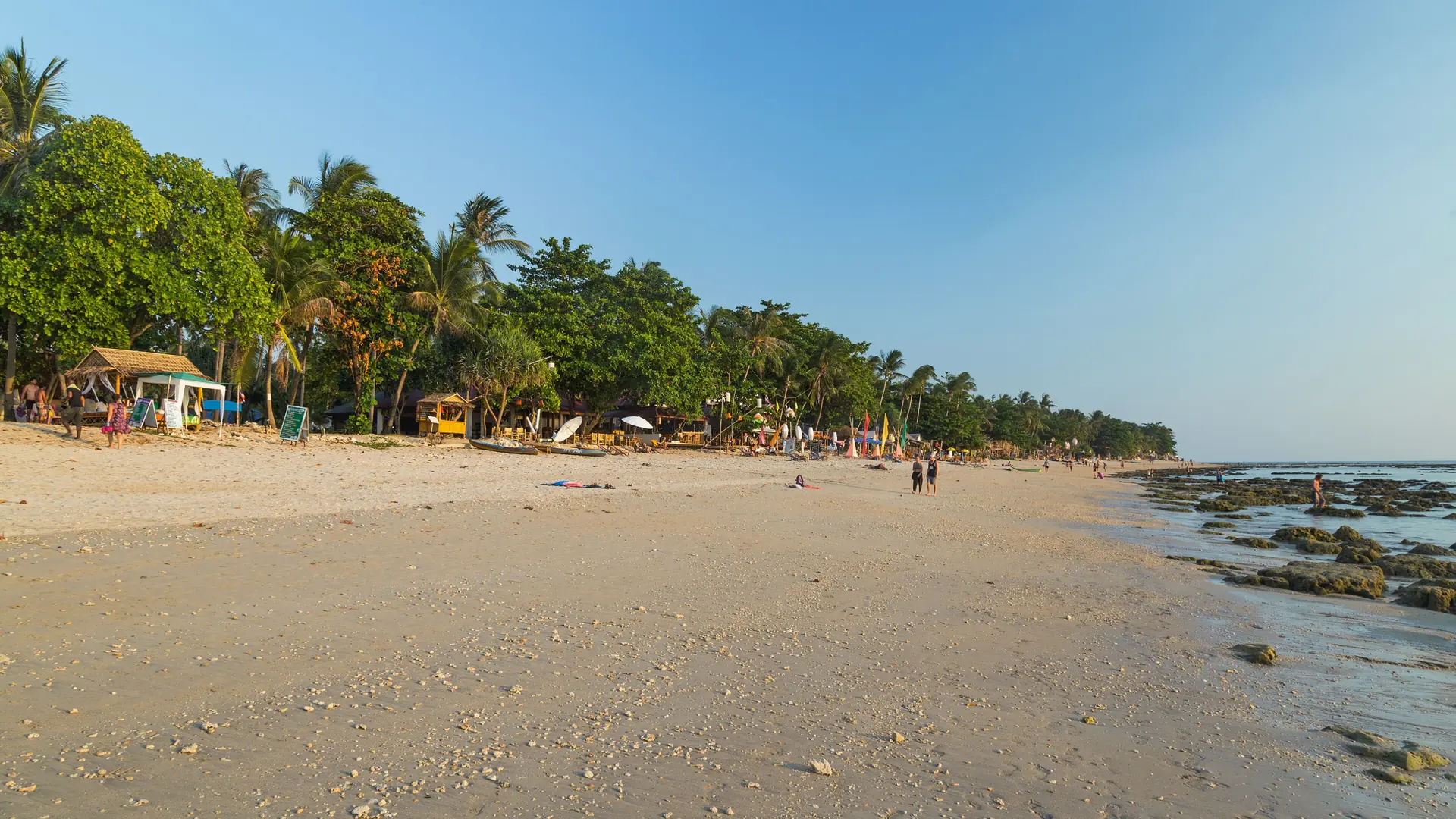 Golden sand, small waves and green hills on Koh Lanta's west coast