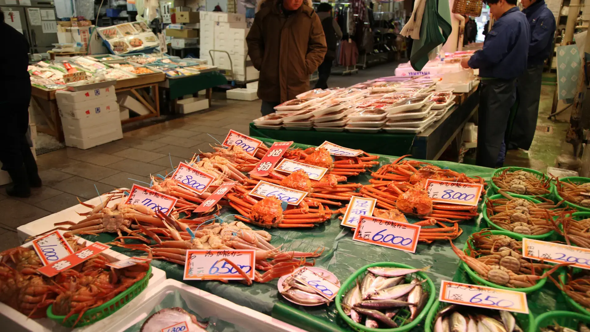 colourful seafood stalls and visitors inside Kanazawa's Omicho Market