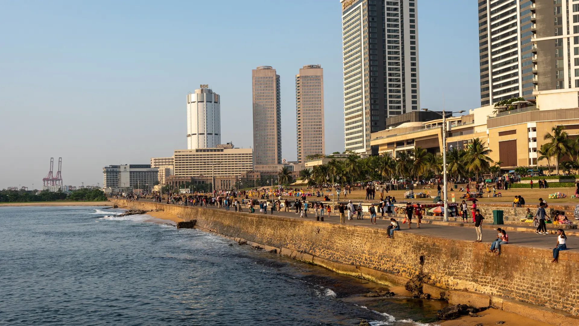Sunny daytime view of the Galle Face promenade and Colombo city buildings