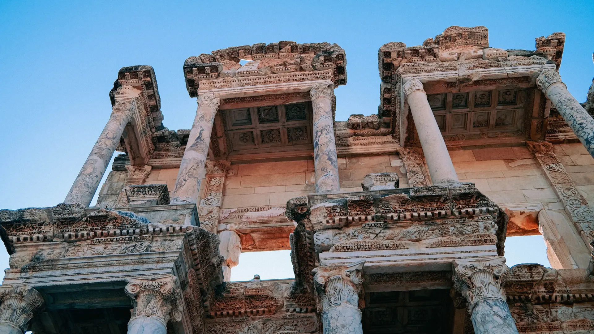 Carved columns and pediments of the Library of Celsus at Ephesus in daylight