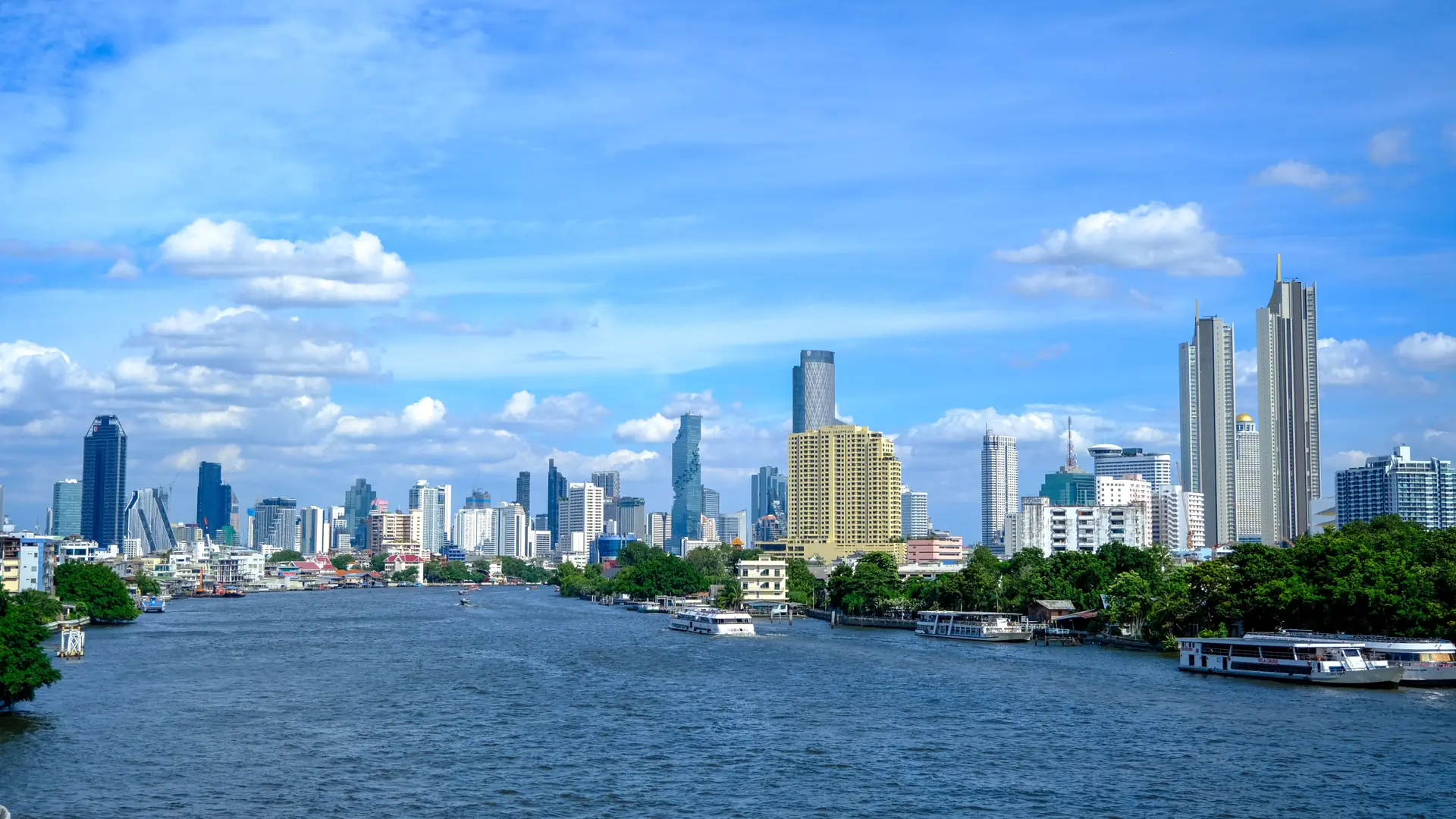 The Chao Phraya River curving past Bangkok towers and waterfront buildings