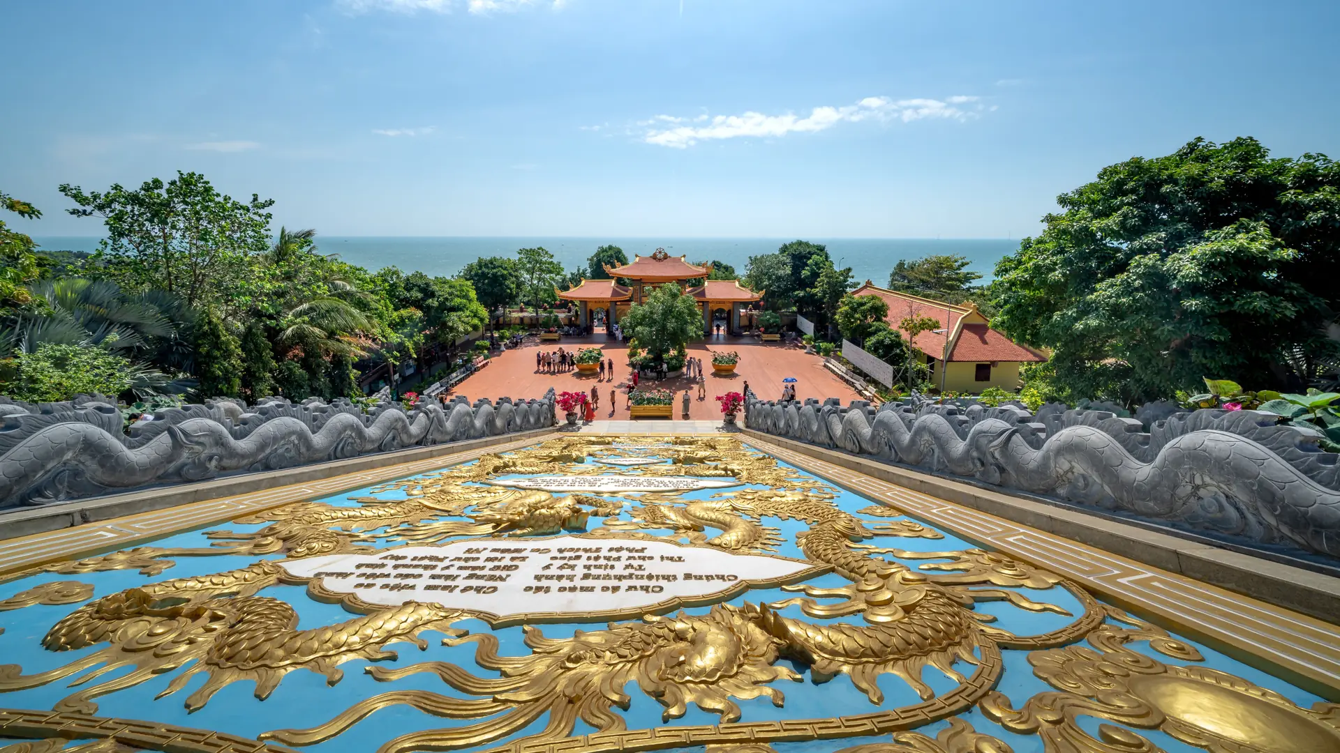 Gold dragon stairway and sea-facing courtyard at Ho Quoc Pagoda, a wider Phu Quoc scene