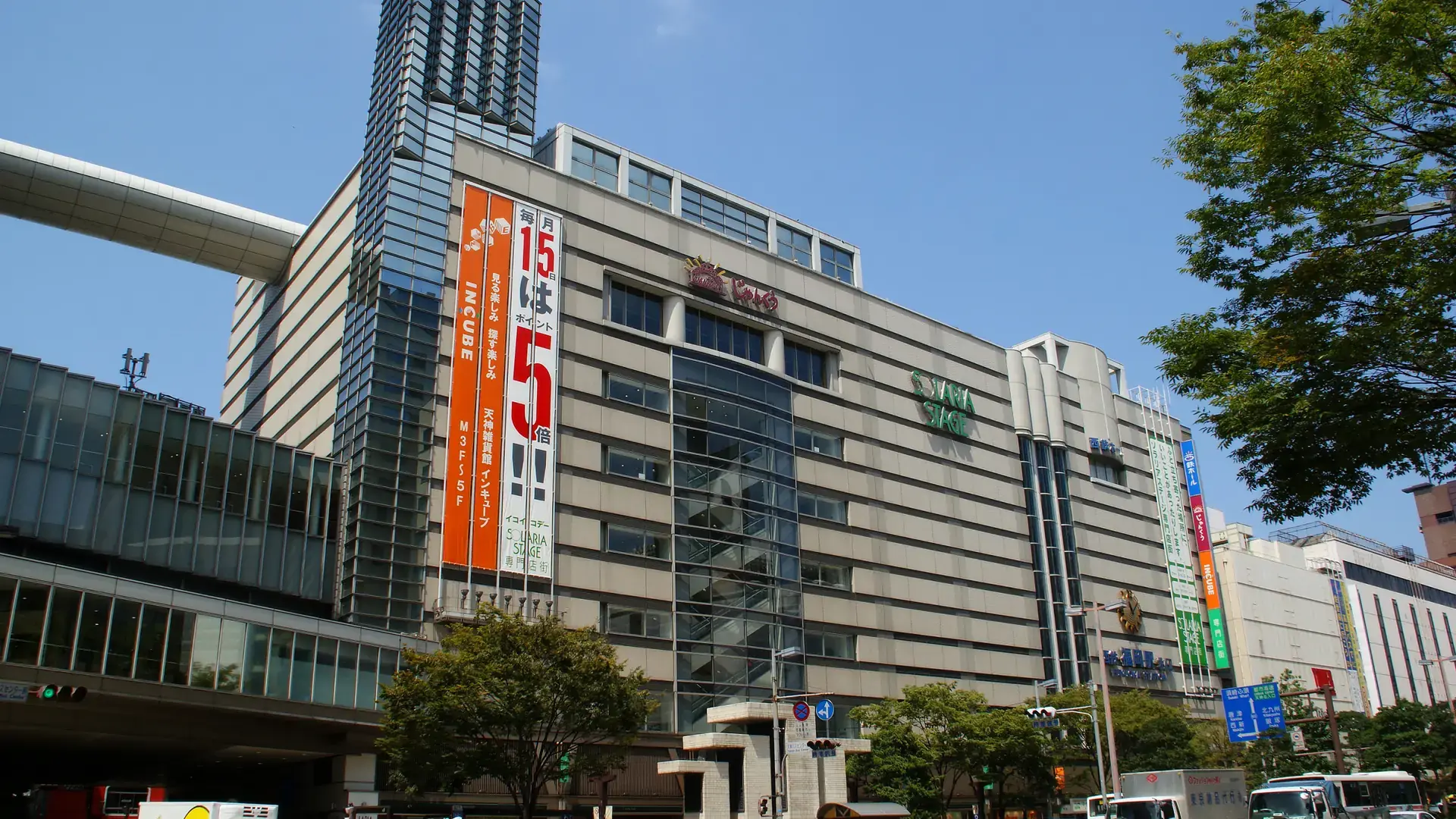 sunlit Tenjin avenue with modern towers and lively pedestrian streets
