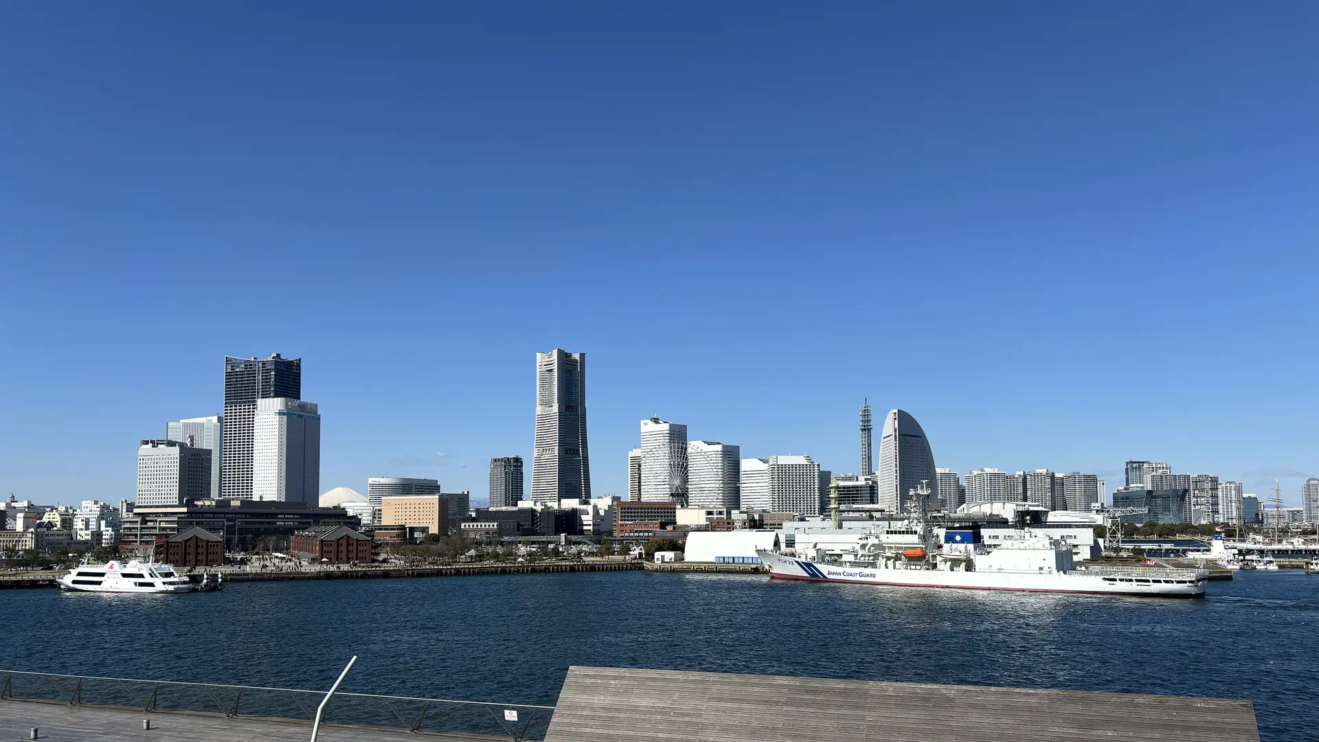 The Minato Mirai skyline across Yokohama’s harbour, with Landmark Tower, the Ferris wheel and the sail-shaped InterContinental hotel.