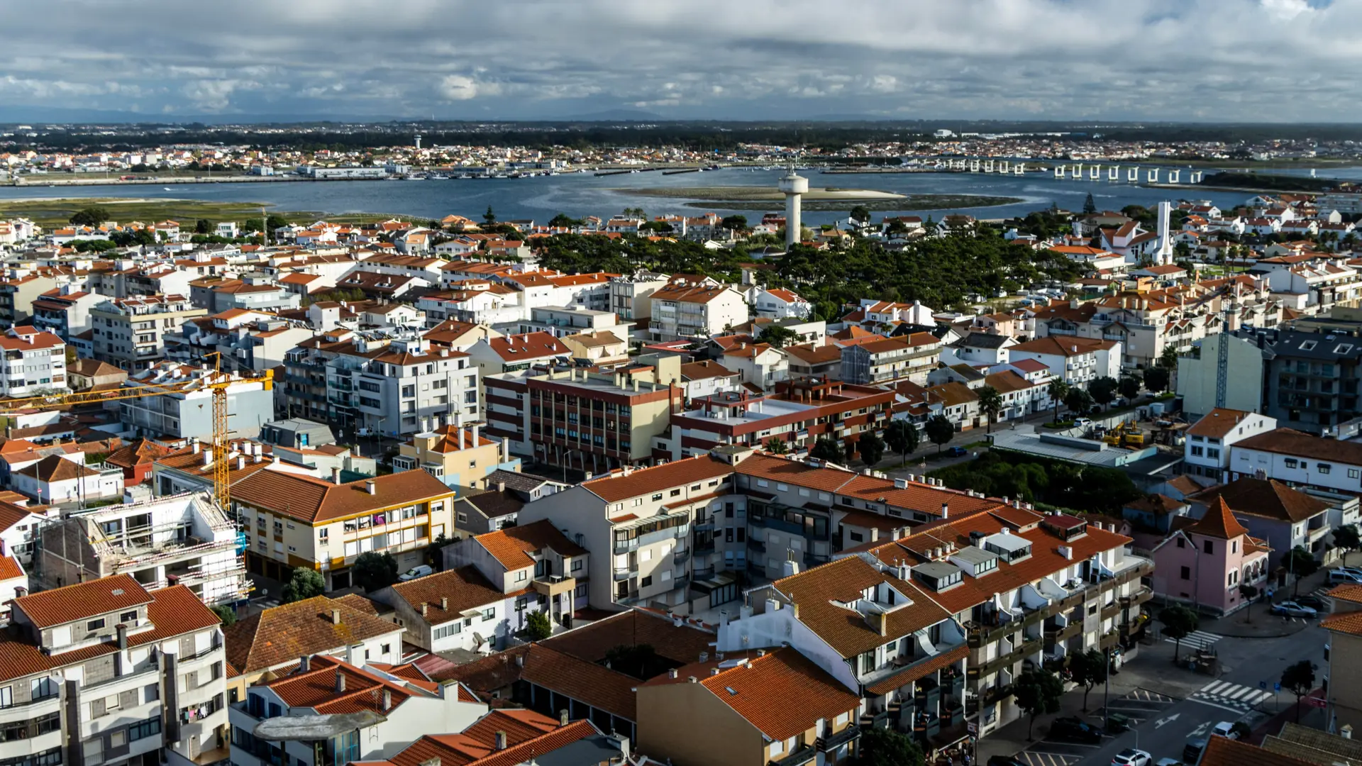 Aerial view of Aveiro’s red-roofed city beside the blue lagoon channels