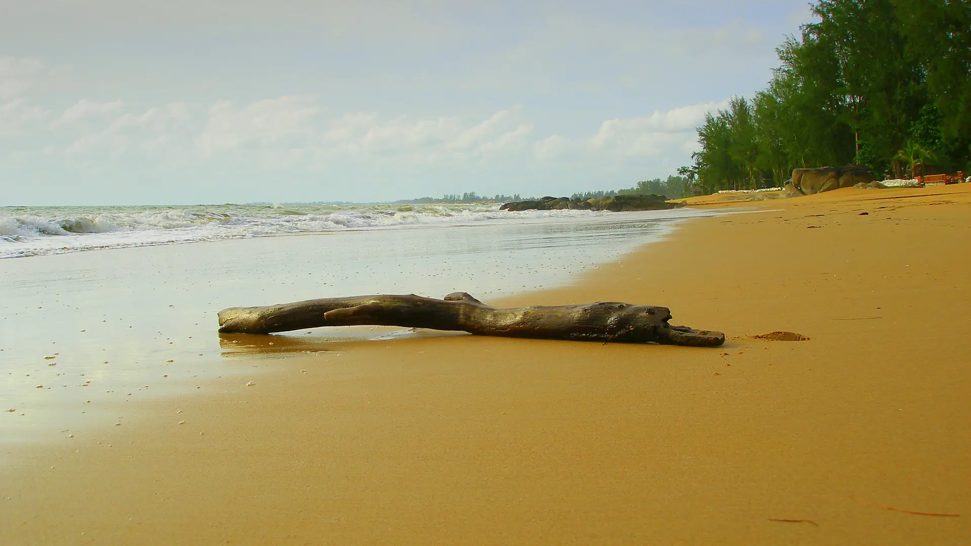 Pale sand and gentle Andaman water along the Khao Lak shoreline