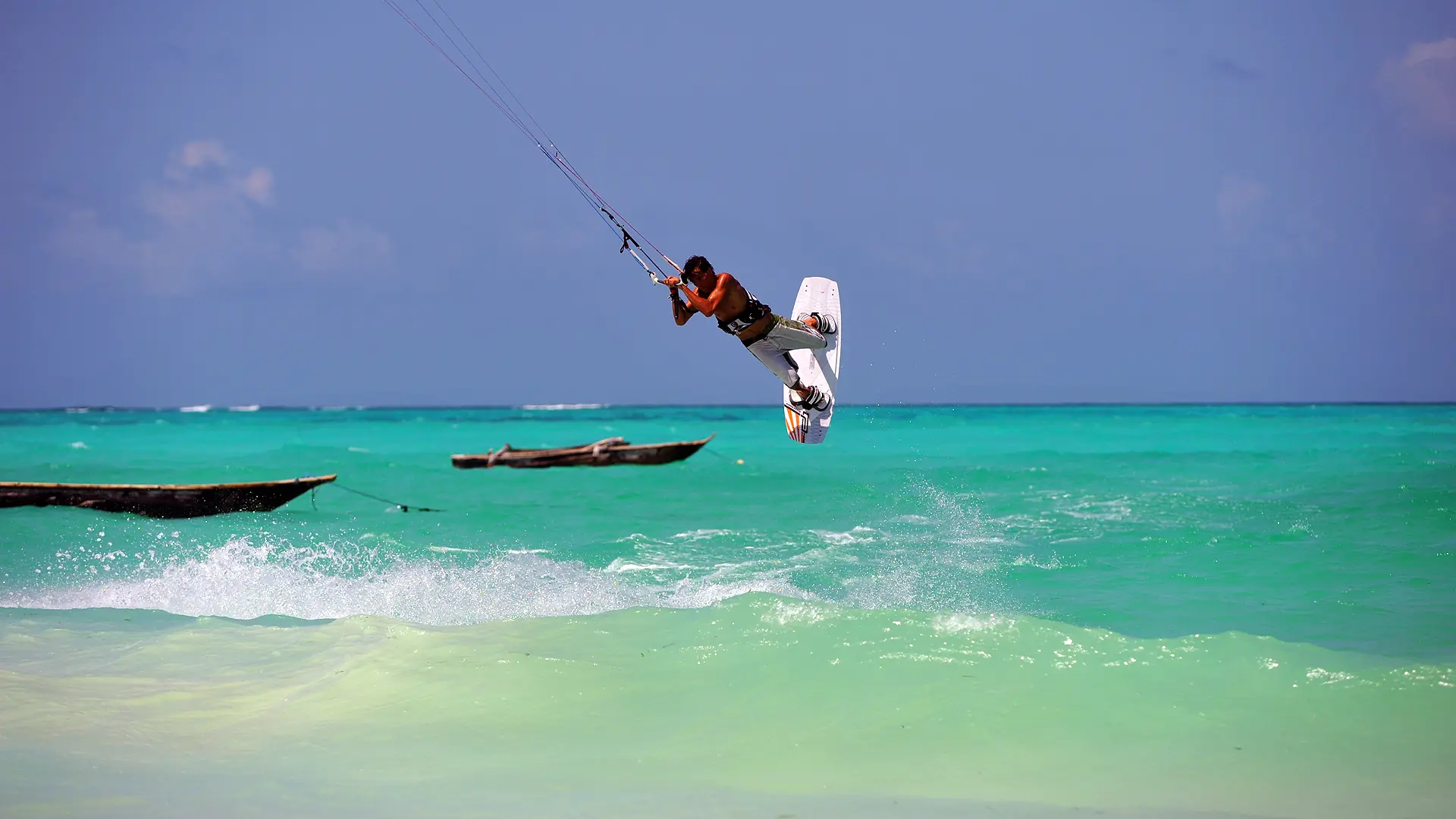 Kiteboarder above turquoise water off Zanzibar Island