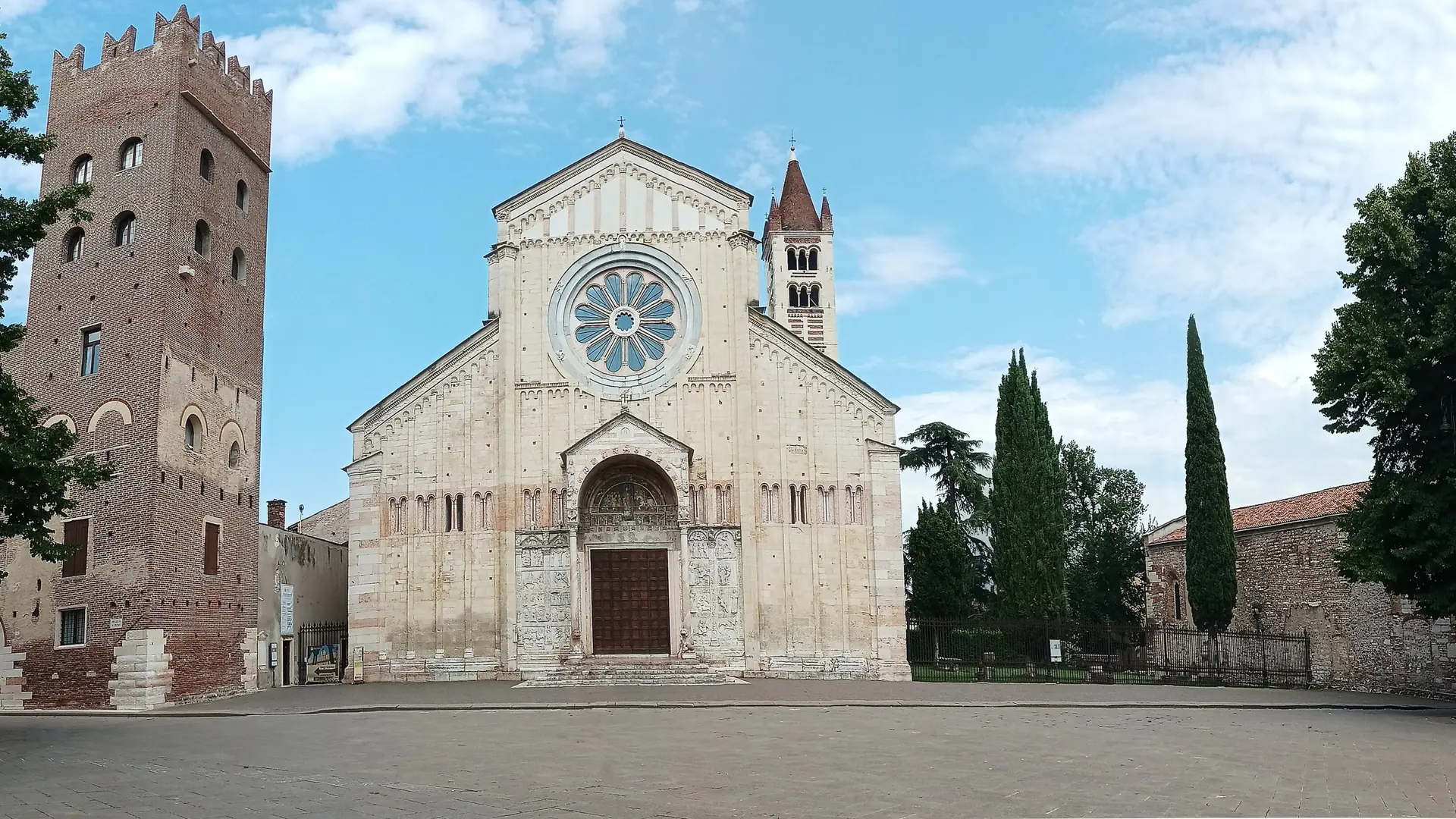 Basilica di San Zeno Maggiore and its piazza in Verona, with a brick tower beside the facade.