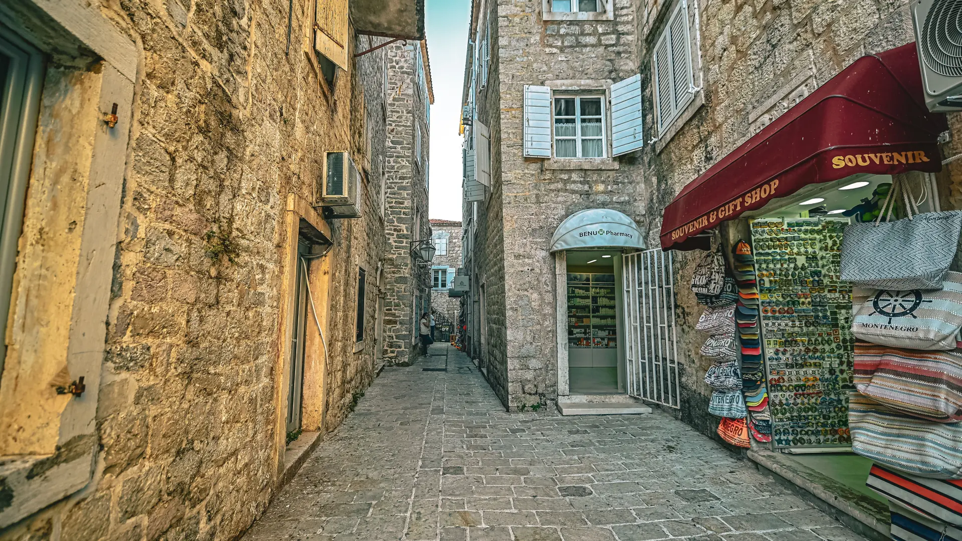 A narrow stone lane with souvenir shops inside Budva's Old Town
