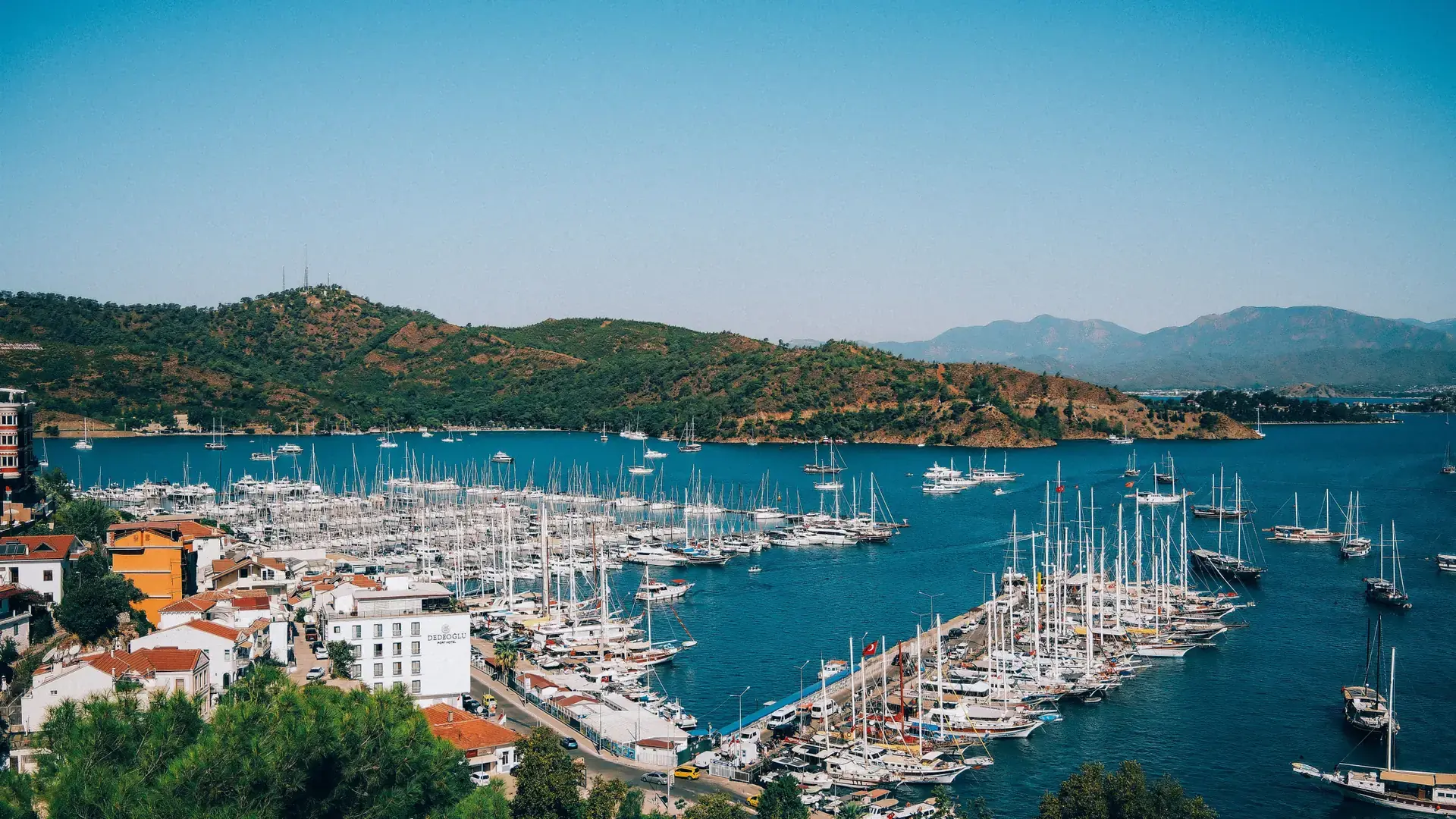 Fethiye marina and waterfront under sunlit Lycian mountains