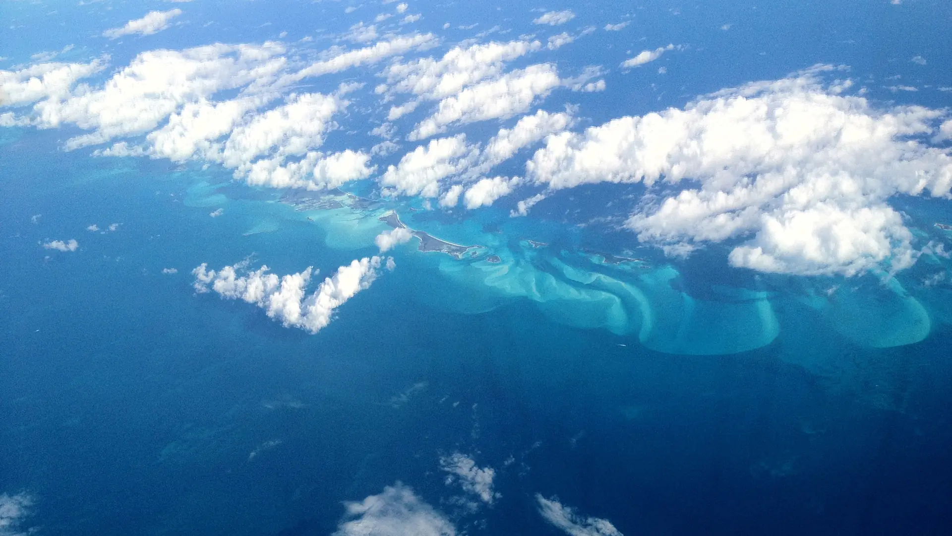 An aerial view of the shallow banks and island chain of the Exumas
