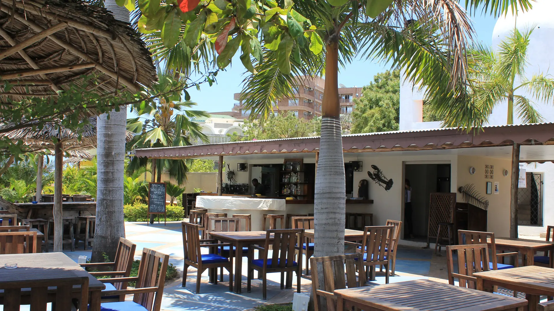 Open-air terrace under palms on the Msasani Peninsula in Dar es Salaam